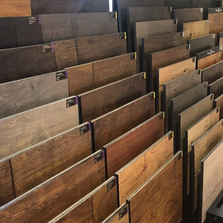 Multiple rows of wood flooring samples in various shades of brown and gray displayed in a store.