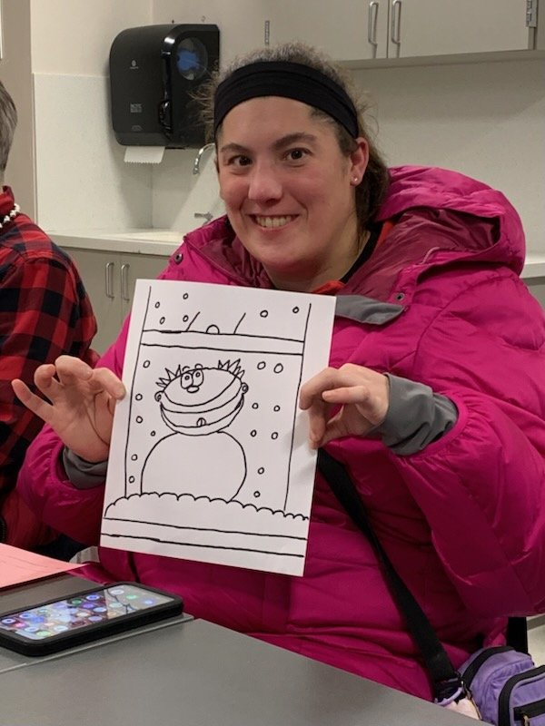 SOAR friend showing off their drawing at a Sketch It! class January 2026