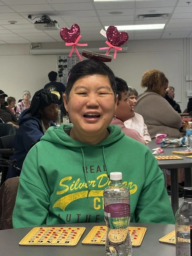 SOAR friend showing off their Valentines Headband prize from BINGO 