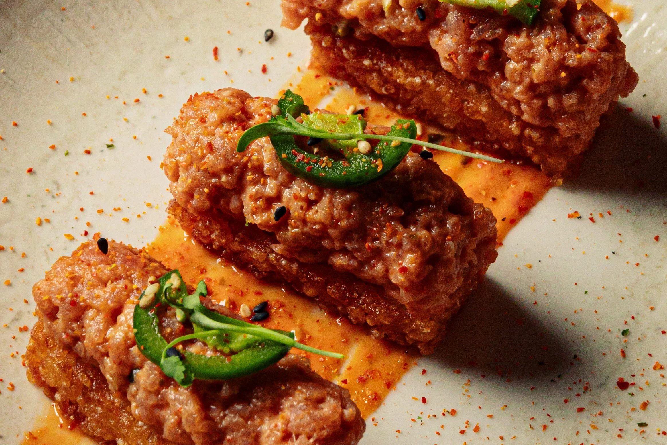 Spicy tuna crispy rice with a garnish of jalapeno and micro cilantro.