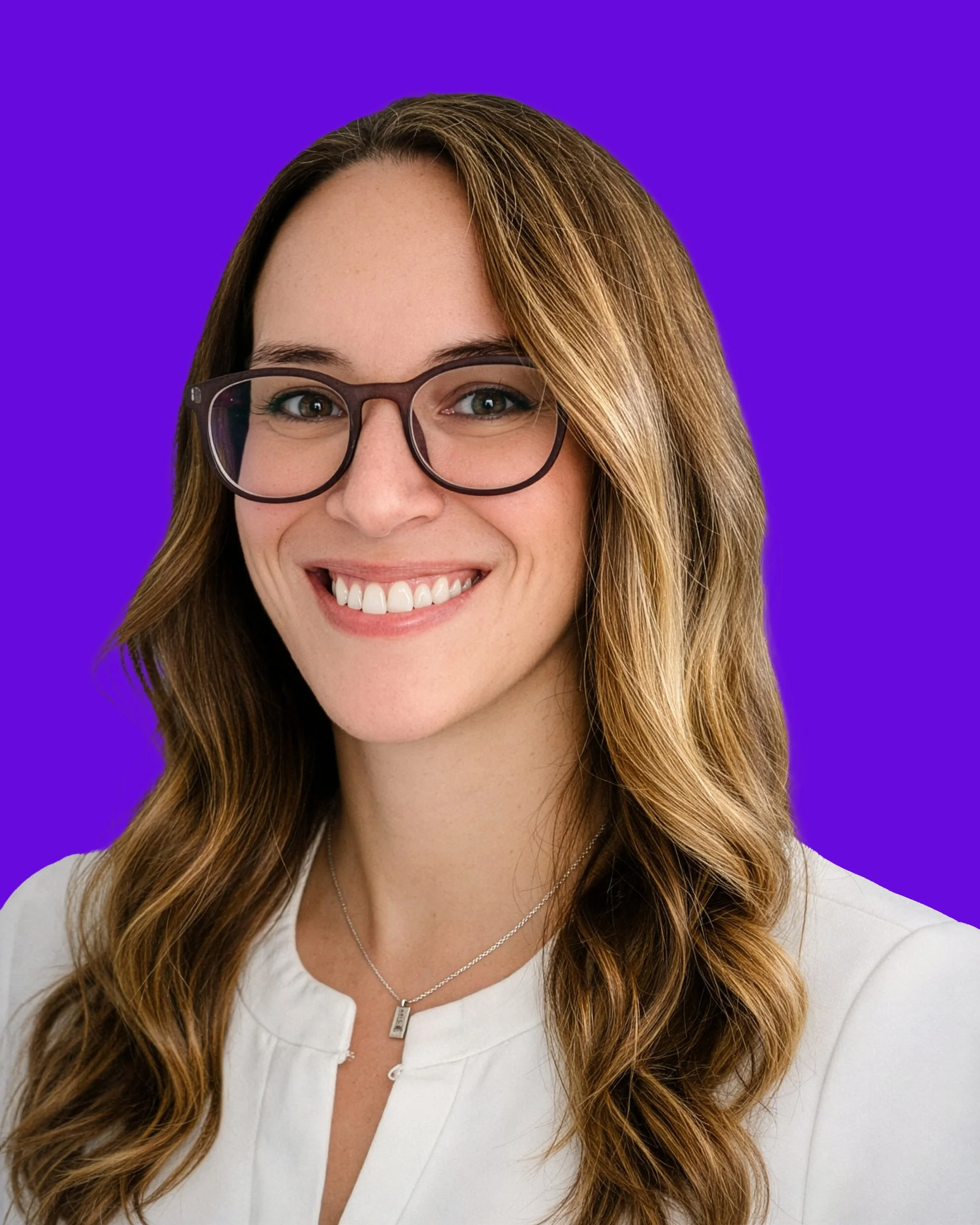 A smiling woman with long wavy brown hair, wearing glasses and a white blouse, against a purple background.