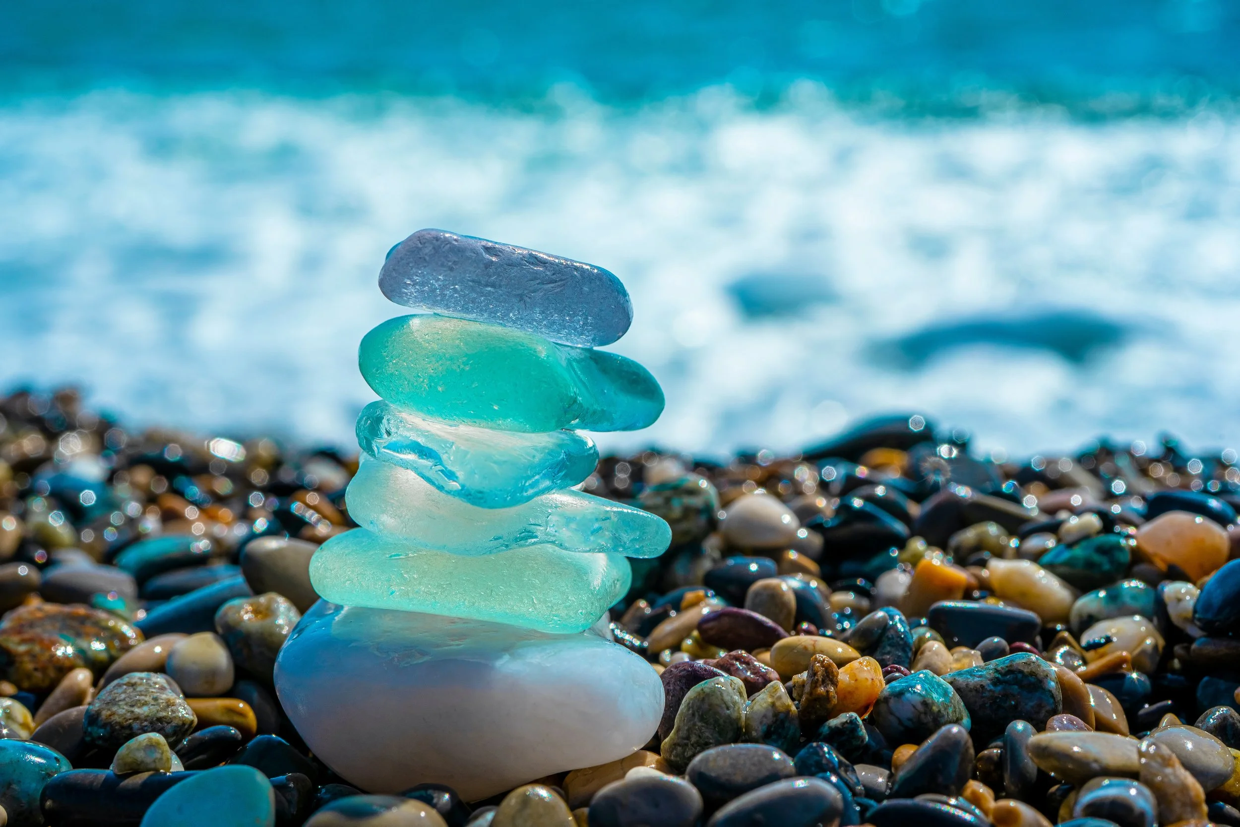 Stone Sea glass stack in front of the ocean to symbolize support
