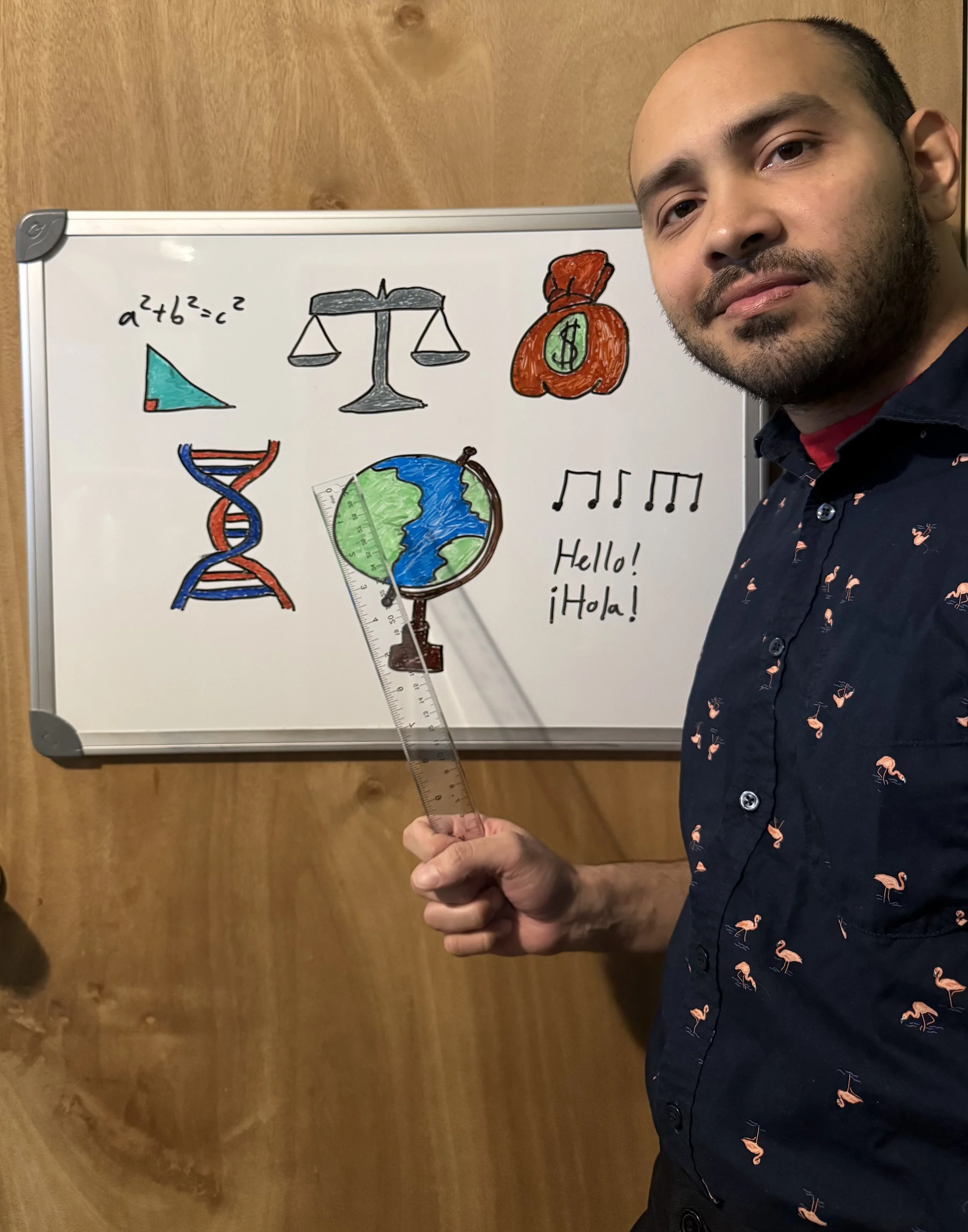 A man holding a ruler in front of a whiteboard with drawn symbols representing science, math, finance, geography, music, and language.