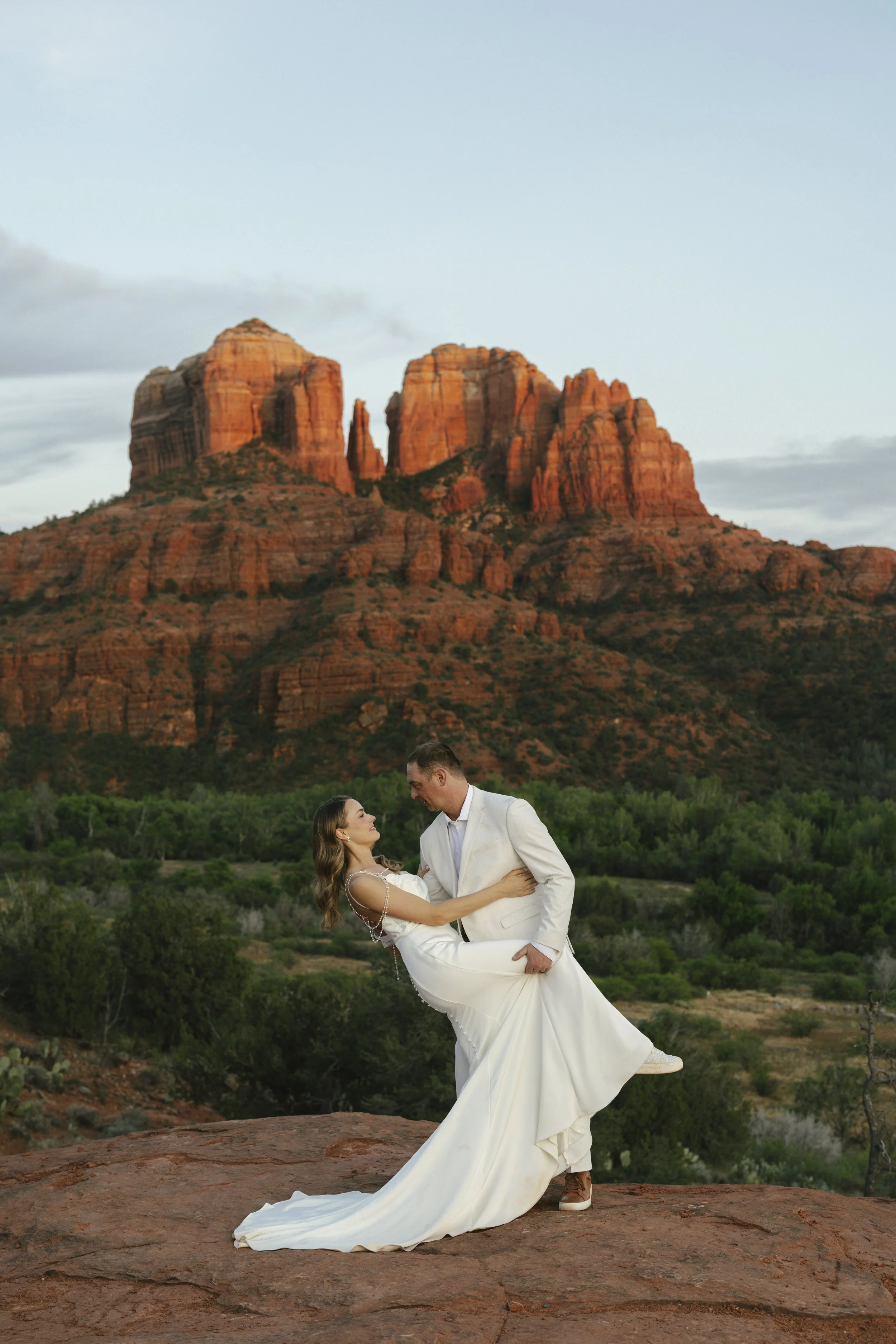 Romantic golden hour portraits at Secret Slick Rock during Chelsea and Travis' intimate Sedona elopement. Featuring Sedona's famous red rock views, stunning Arizona desert landscapes, and timeless wedding photography, these newlywed portraits perfect
