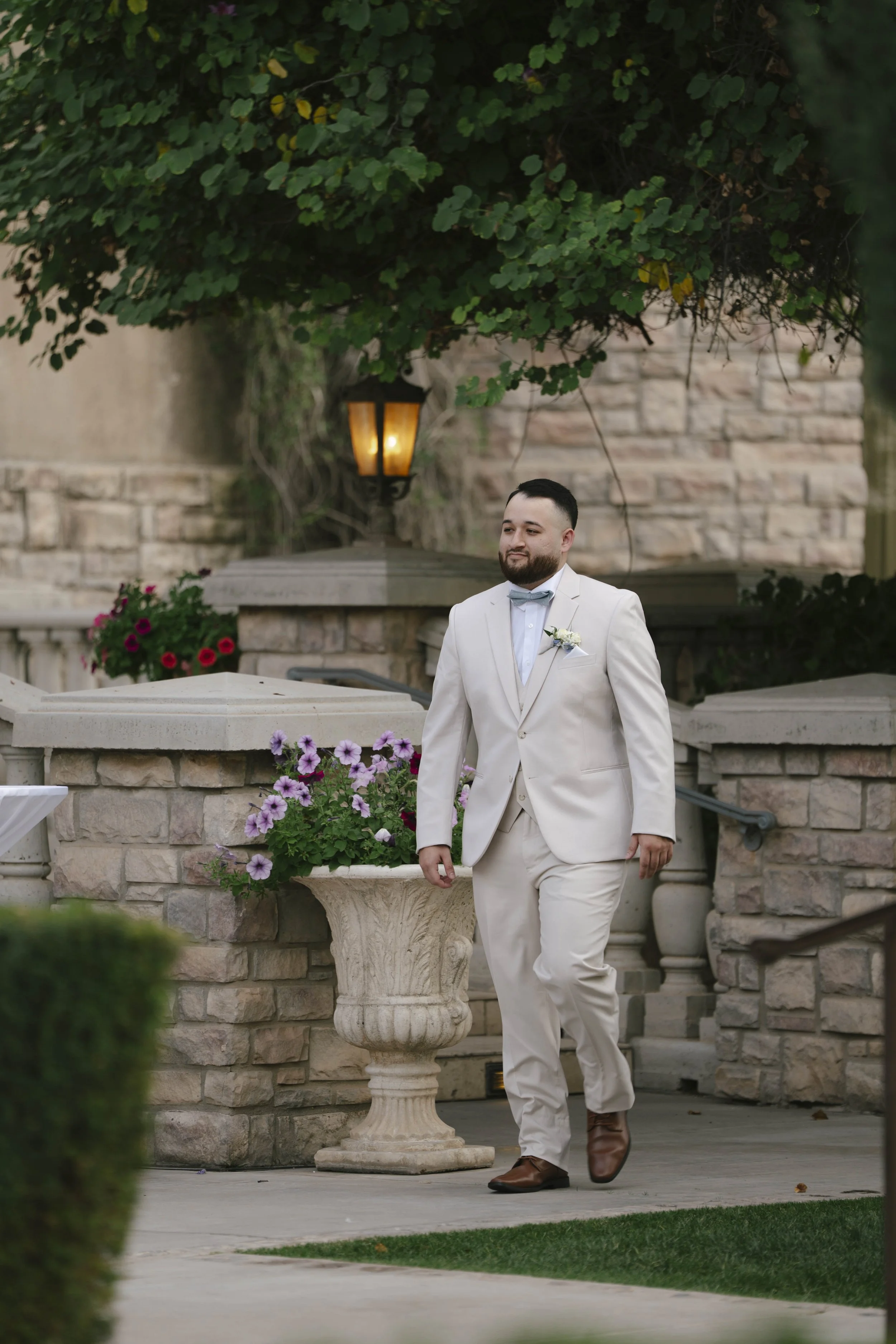 The wedding processional at Ashley Castle in Chandler, Arizona, was captured through hybrid film and digital photography, preserving the graceful entrances of the bridal party as they made their way through the romantic outdoor ceremony space surroun