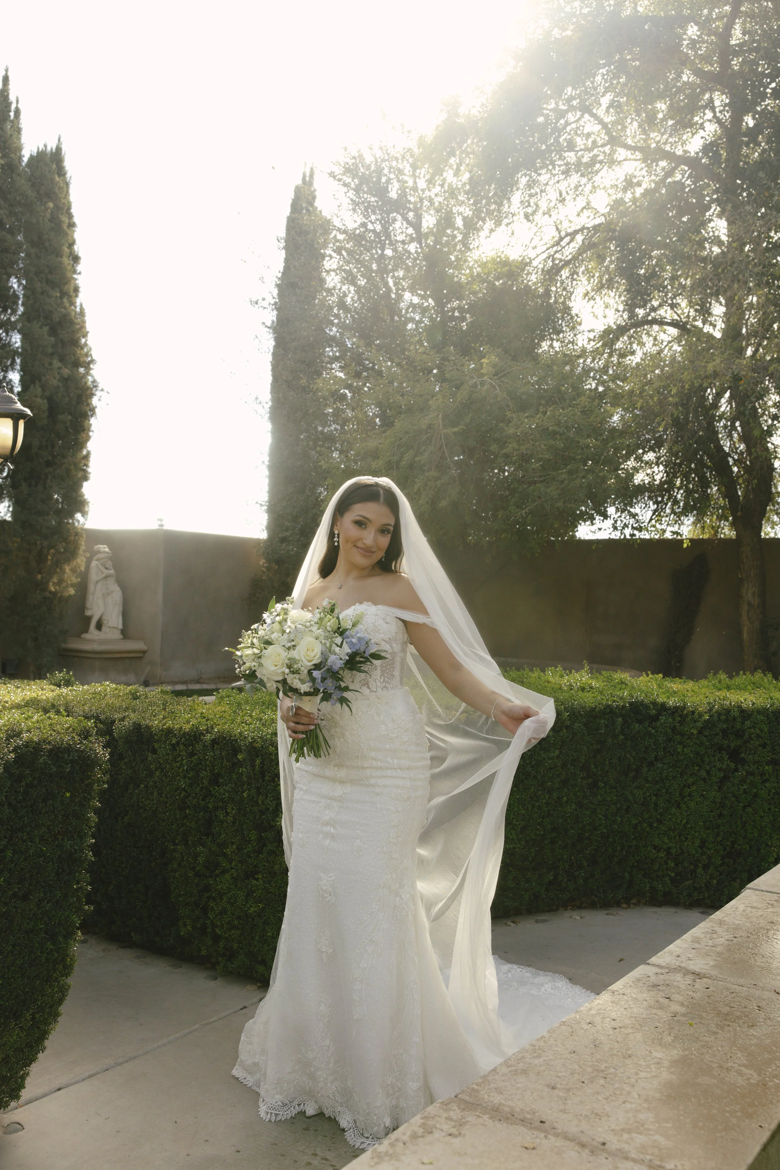Romantic bride and groom portraits at Ashley Castle in Chandler, Arizona, captured through hybrid film and digital photography, showcase intimate newlywed moments filled with emotion, elegant garden backdrops, and timeless wedding-day connection.