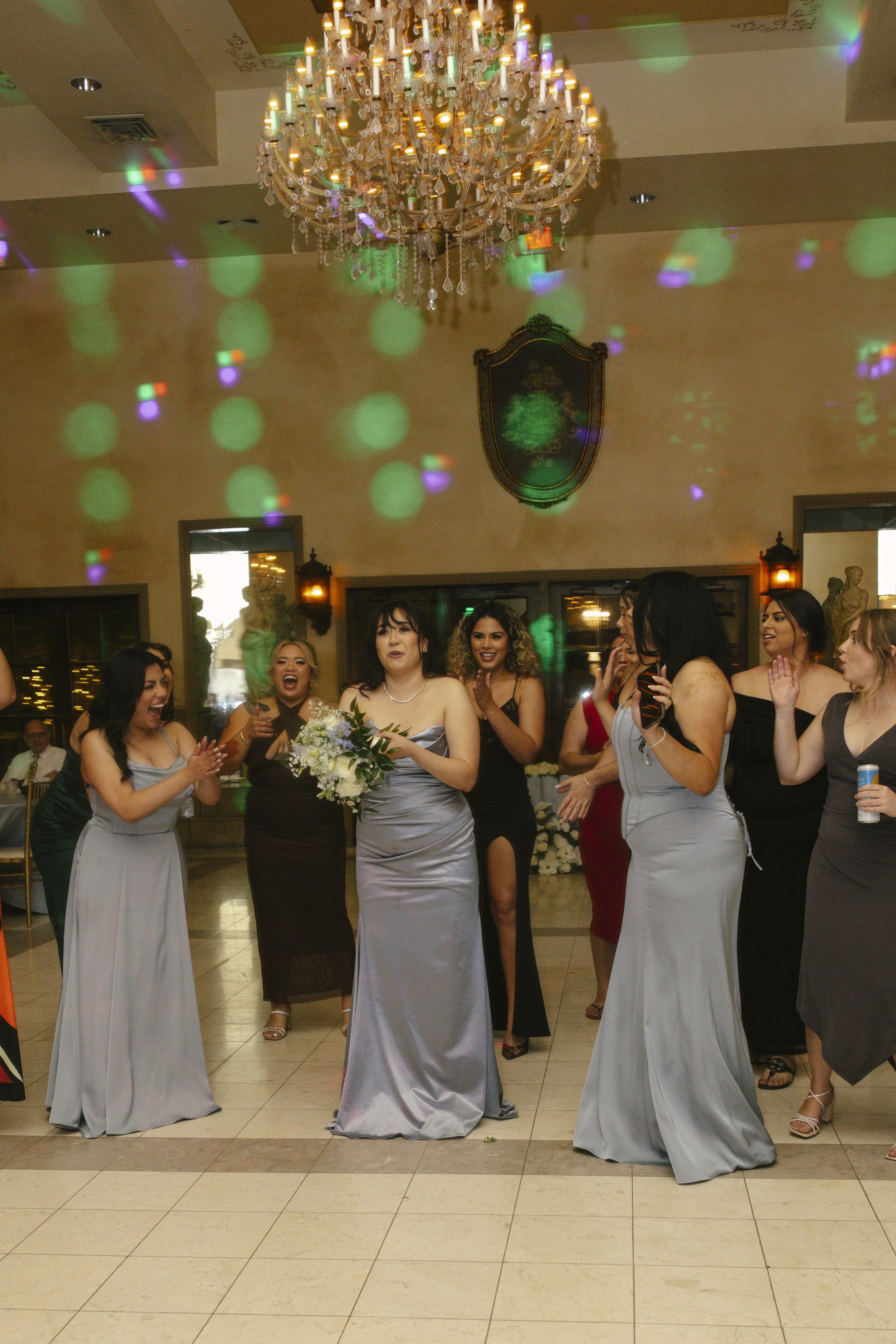 The reception celebration at Ashley Castle in Chandler, Arizona, came to life through hybrid film and digital photography, capturing elegant reception details, joyful bridal party entrances, and lively dance floor moments inside the castle’s grand ba