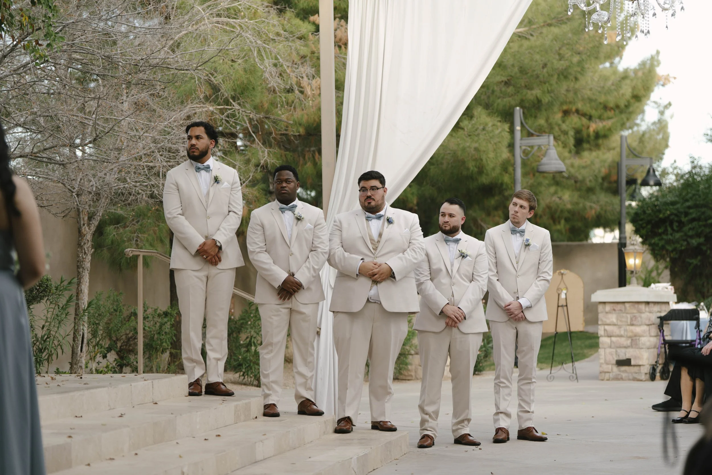 The bride and groom’s ceremony at Ashley Castle in Chandler, Arizona, was beautifully documented through hybrid film and digital photography, capturing their vows, ring exchange, and heartfelt moments beneath a romantic floral altar in the castle’s e