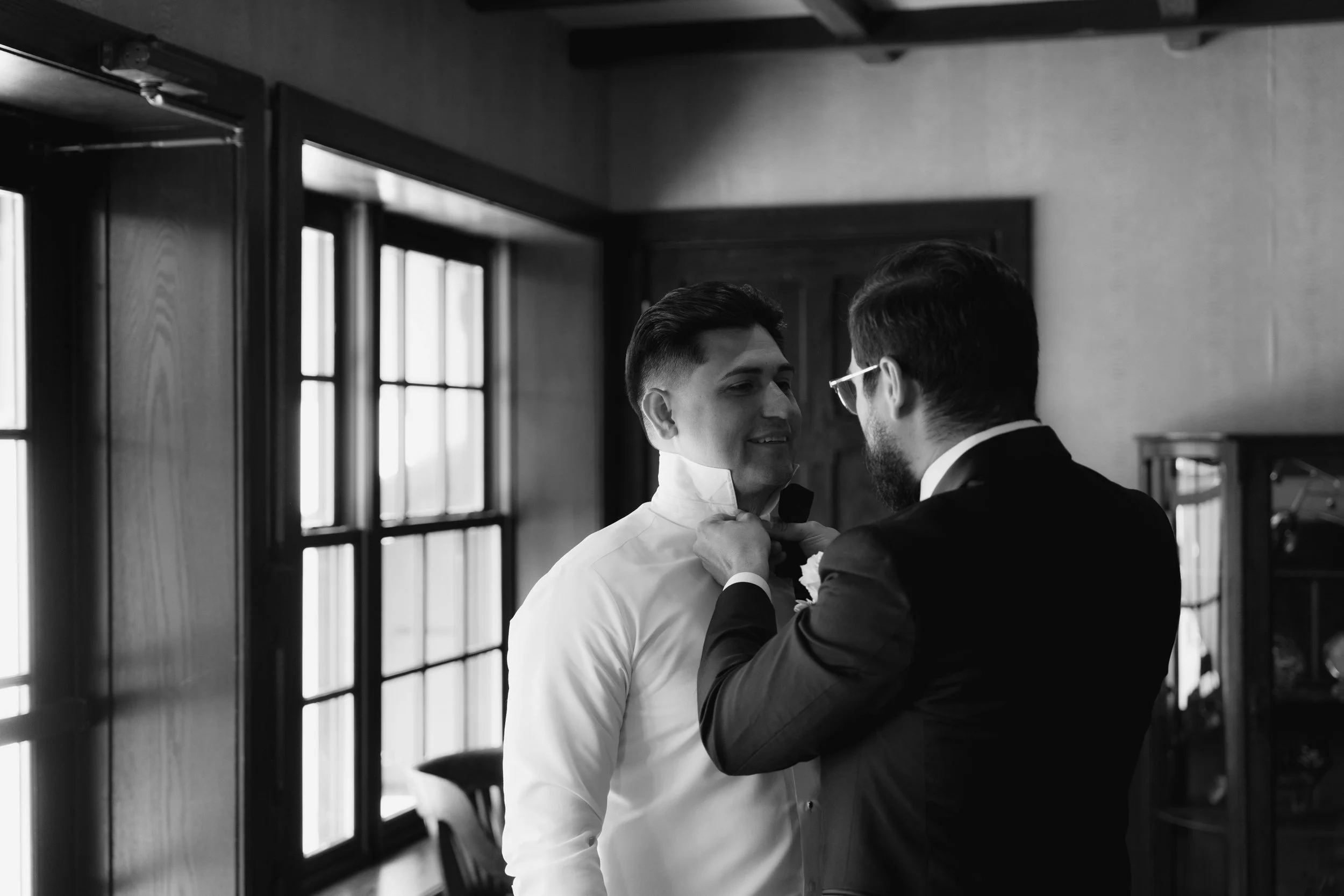 Groom getting ready at Hotel DuVillage before Andy & Elmer's May 2026 wedding. Captured by Raw By Laura using a blend of digital and 35mm film photography, documenting genuine moments with family and friends.