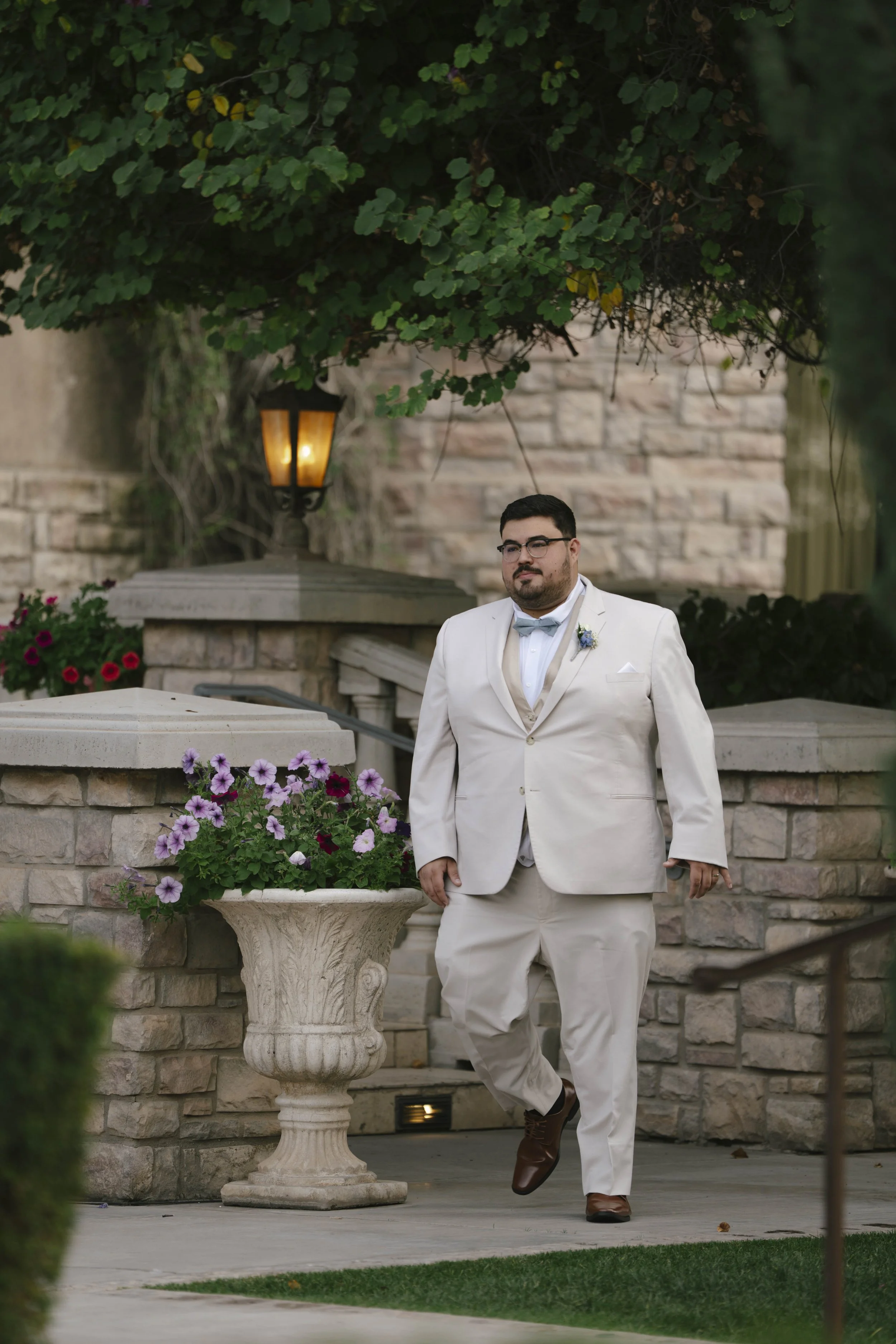 The wedding processional at Ashley Castle in Chandler, Arizona, was captured through hybrid film and digital photography, preserving the graceful entrances of the bridal party as they made their way through the romantic outdoor ceremony space surroun