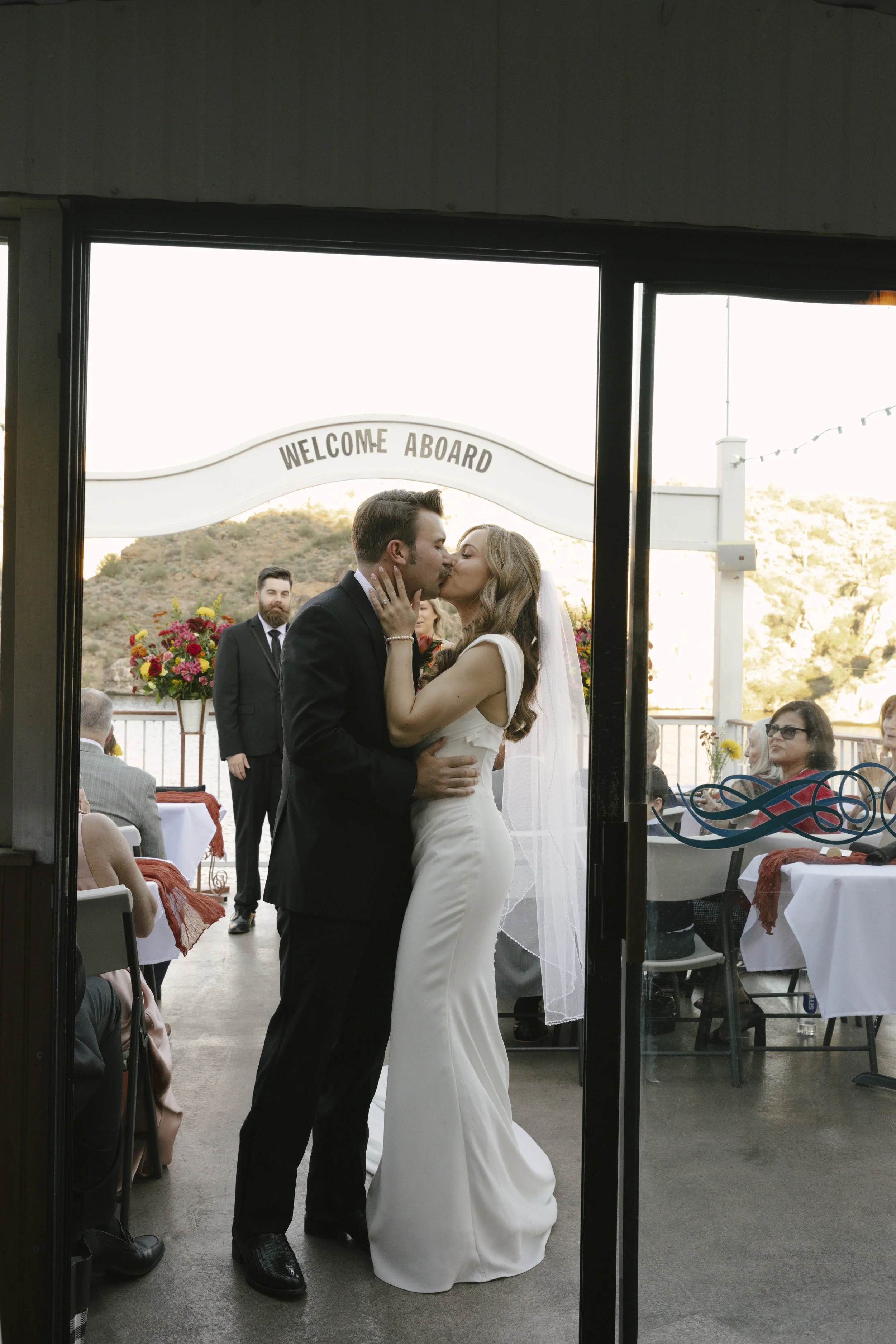 With Canyon Lake’s towering desert cliffs surrounding them, the couple exchanged rings and said “I do” aboard the Dolly Steamboat. Surrounded by about 60 of their closest friends and family, the ceremony took place on the deck with breathtaking Arizo