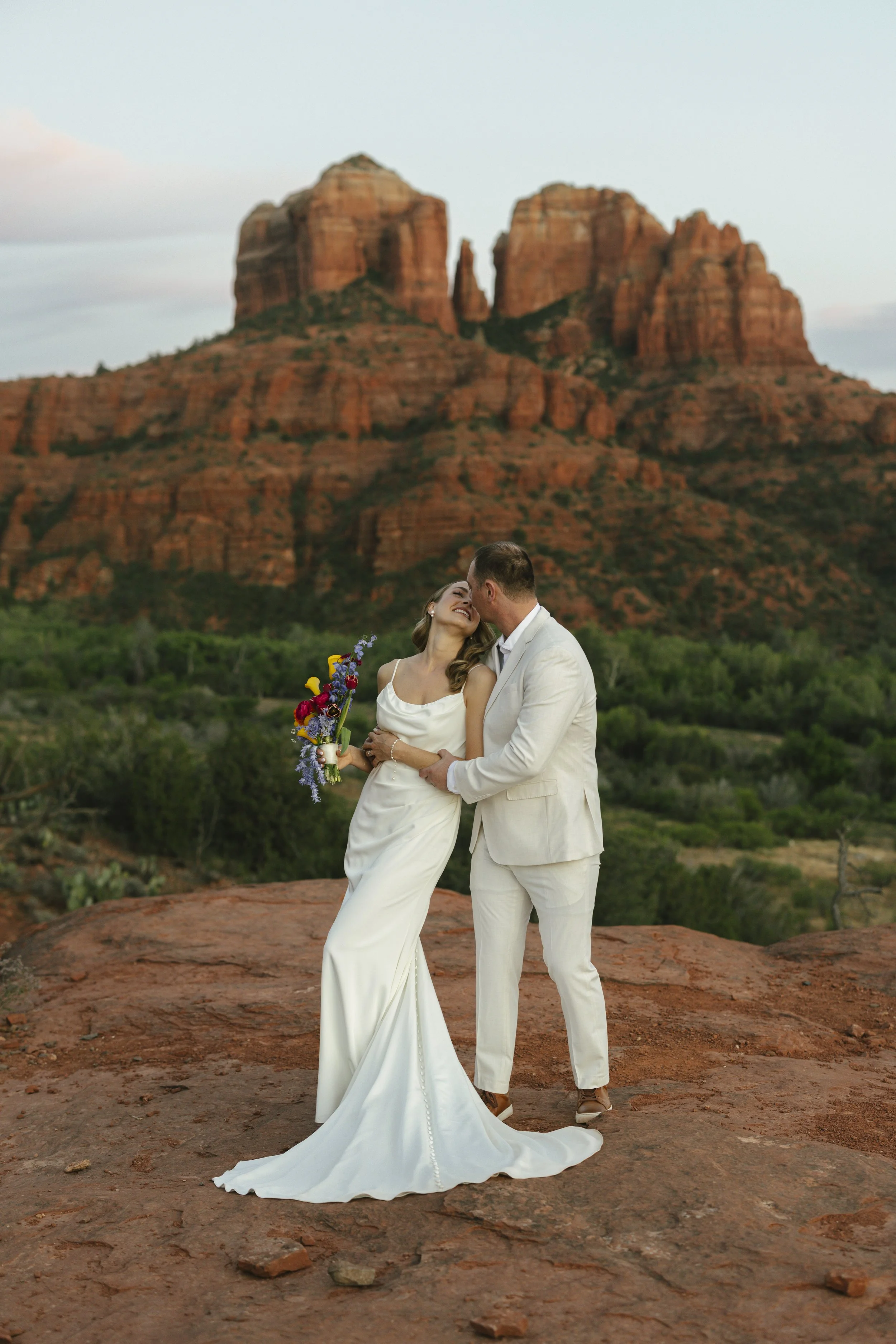 Romantic golden hour portraits at Secret Slick Rock during Chelsea and Travis' intimate Sedona elopement. Featuring Sedona's famous red rock views, stunning Arizona desert landscapes, and timeless wedding photography, these newlywed portraits perfect