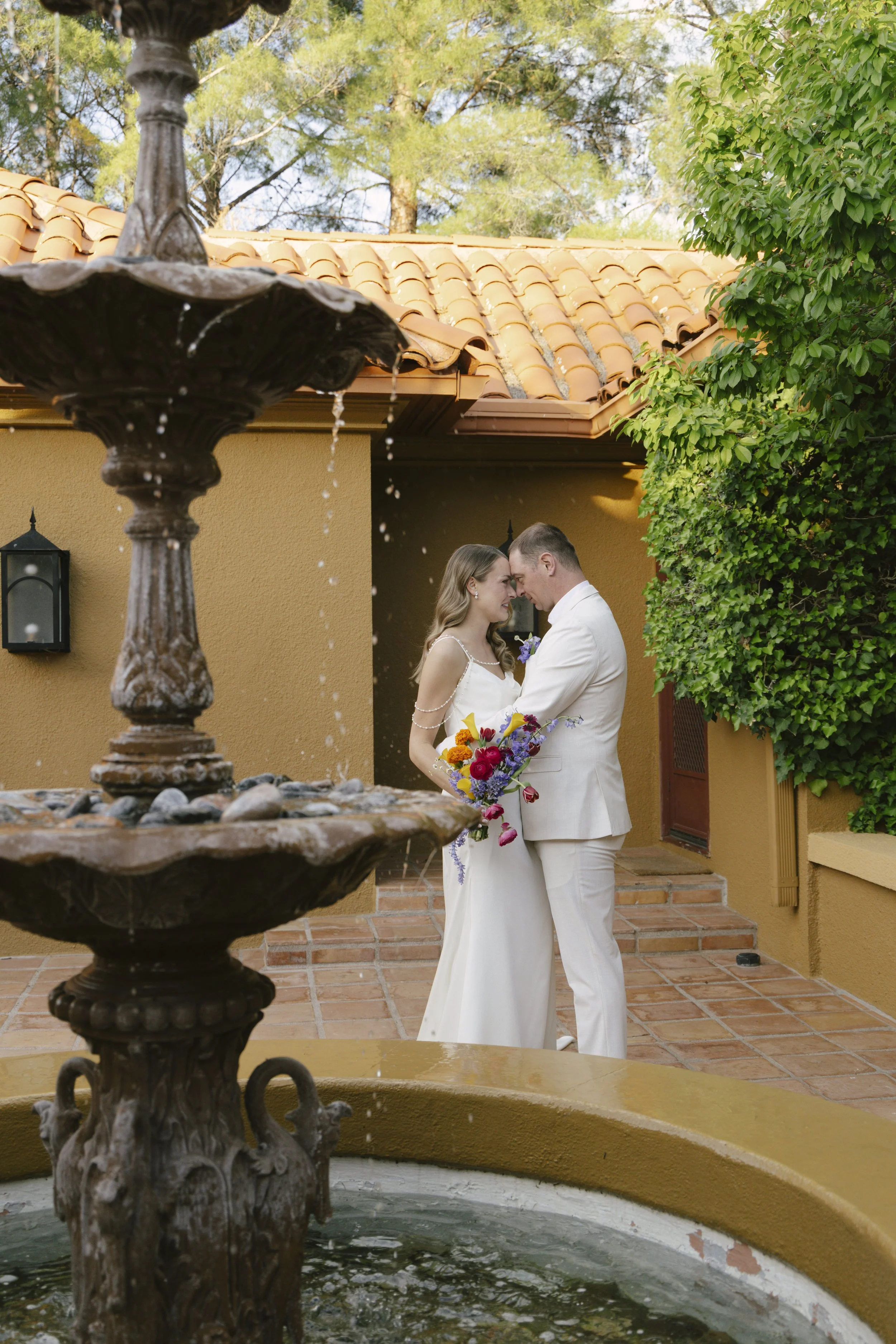 Romantic newlywed portraits from Chelsea and Travis' intimate Sedona, Arizona elopement, featuring elegant courtyard portraits, candid moments with their beloved dog, and timeless wedding photography captured after their private ceremony before golde