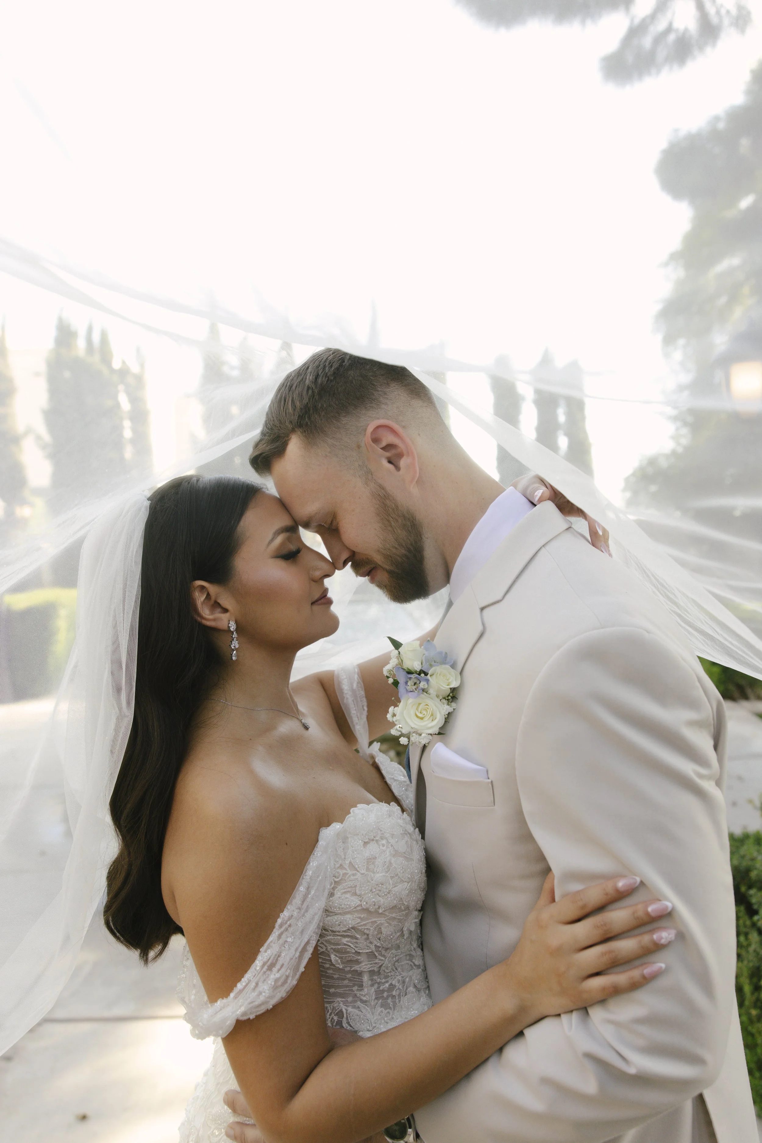 Romantic bride and groom portraits at Ashley Castle in Chandler, Arizona, captured through hybrid film and digital photography, showcase intimate newlywed moments filled with emotion, elegant garden backdrops, and timeless wedding-day connection.