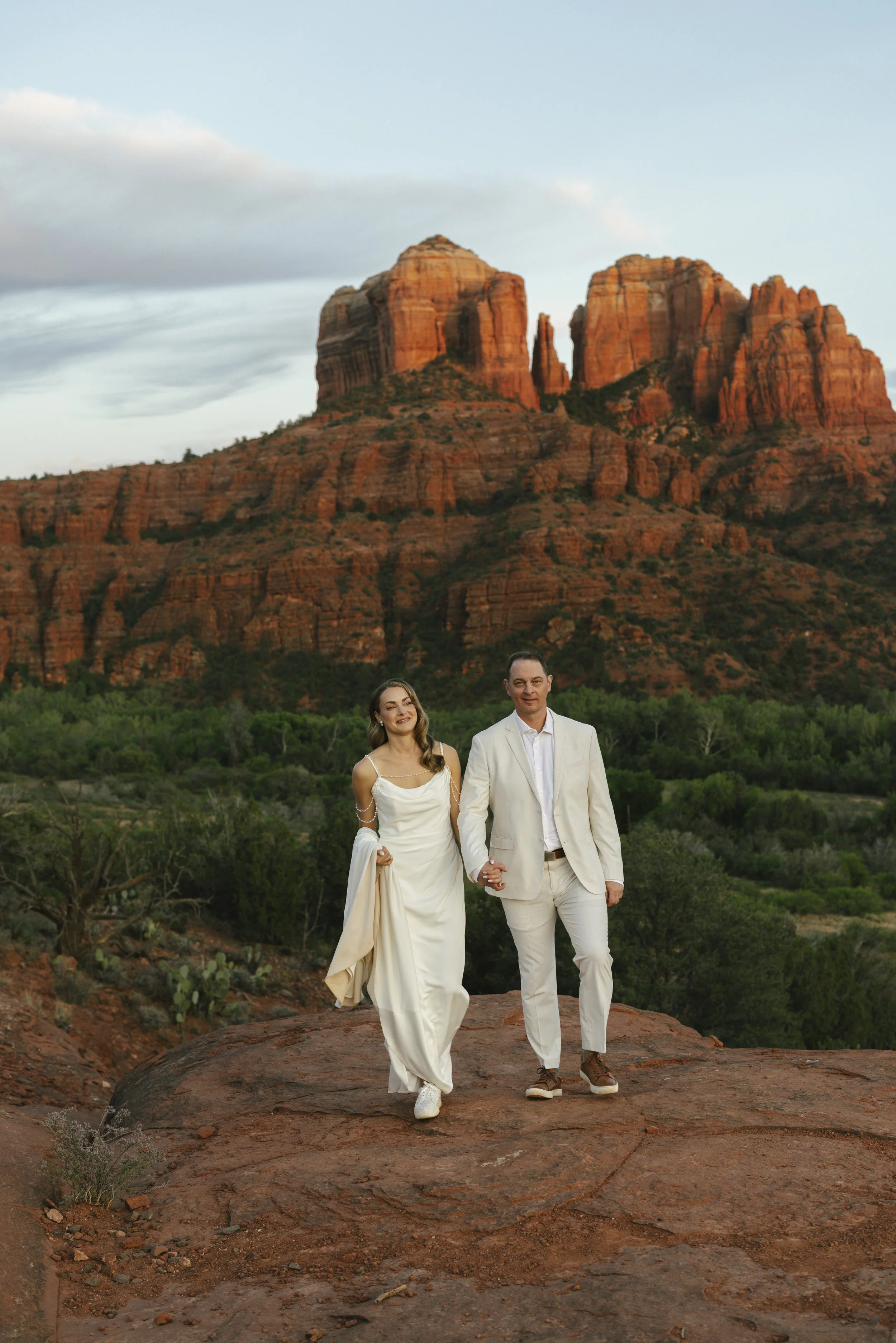 Romantic golden hour portraits at Secret Slick Rock during Chelsea and Travis' intimate Sedona elopement. Featuring Sedona's famous red rock views, stunning Arizona desert landscapes, and timeless wedding photography, these newlywed portraits perfect
