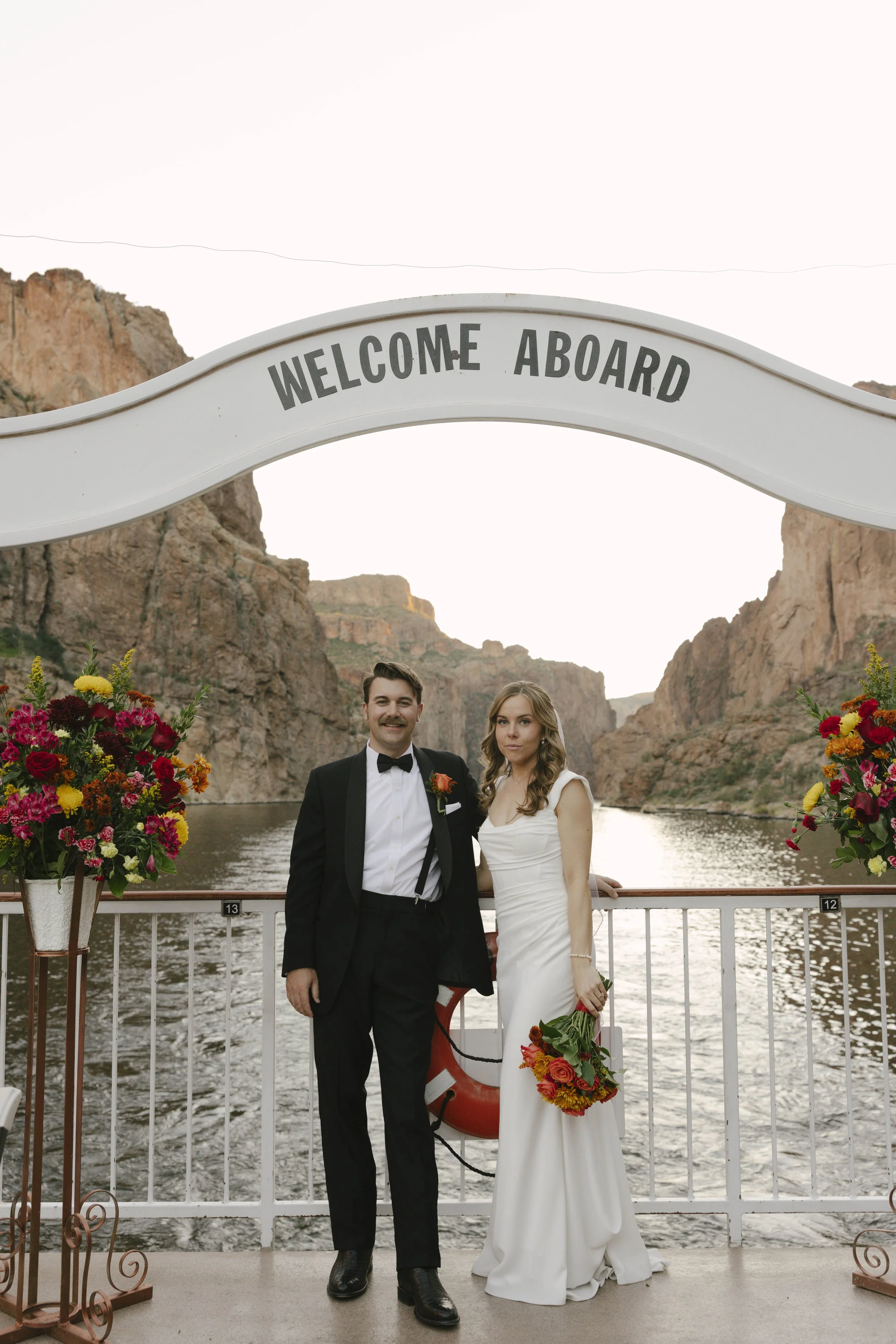 As the sun began to set over Canyon Lake, the couple stepped onto the deck of the Dolly Steamboat for golden hour portraits. With warm Arizona light reflecting off the water and desert mountains surrounding them, these quiet moments captured the beau
