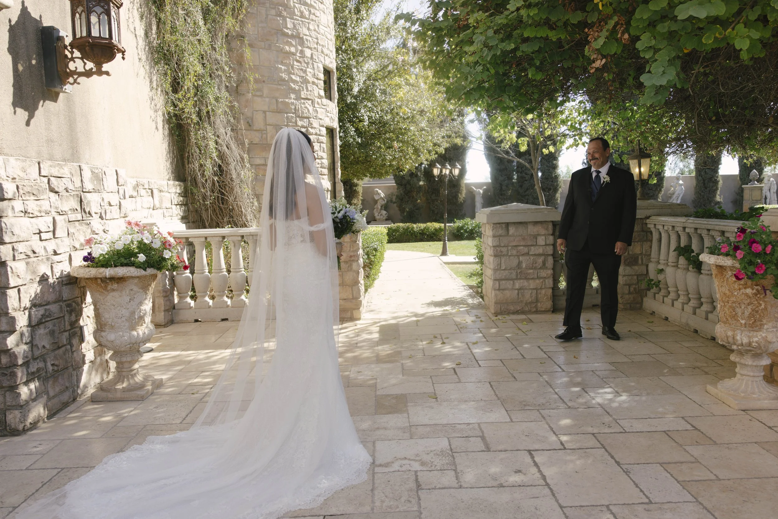 The bride’s first look with her father at Ashley Castle in Chandler, Arizona, was a heartfelt and emotional moment, beautifully documented through hybrid film and digital photography to preserve the joy, love, and anticipation shared before the cerem