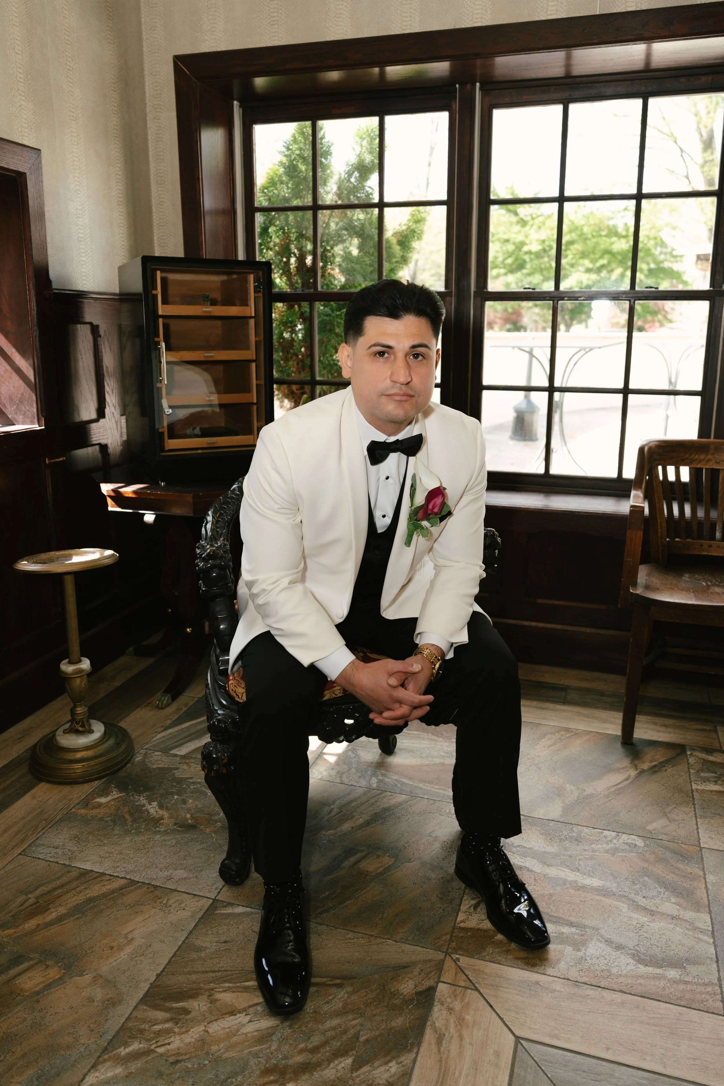 Groom getting ready at Hotel DuVillage before Andy & Elmer's May 2026 wedding. Captured by Raw By Laura using a blend of digital and 35mm film photography, documenting genuine moments with family and friends.