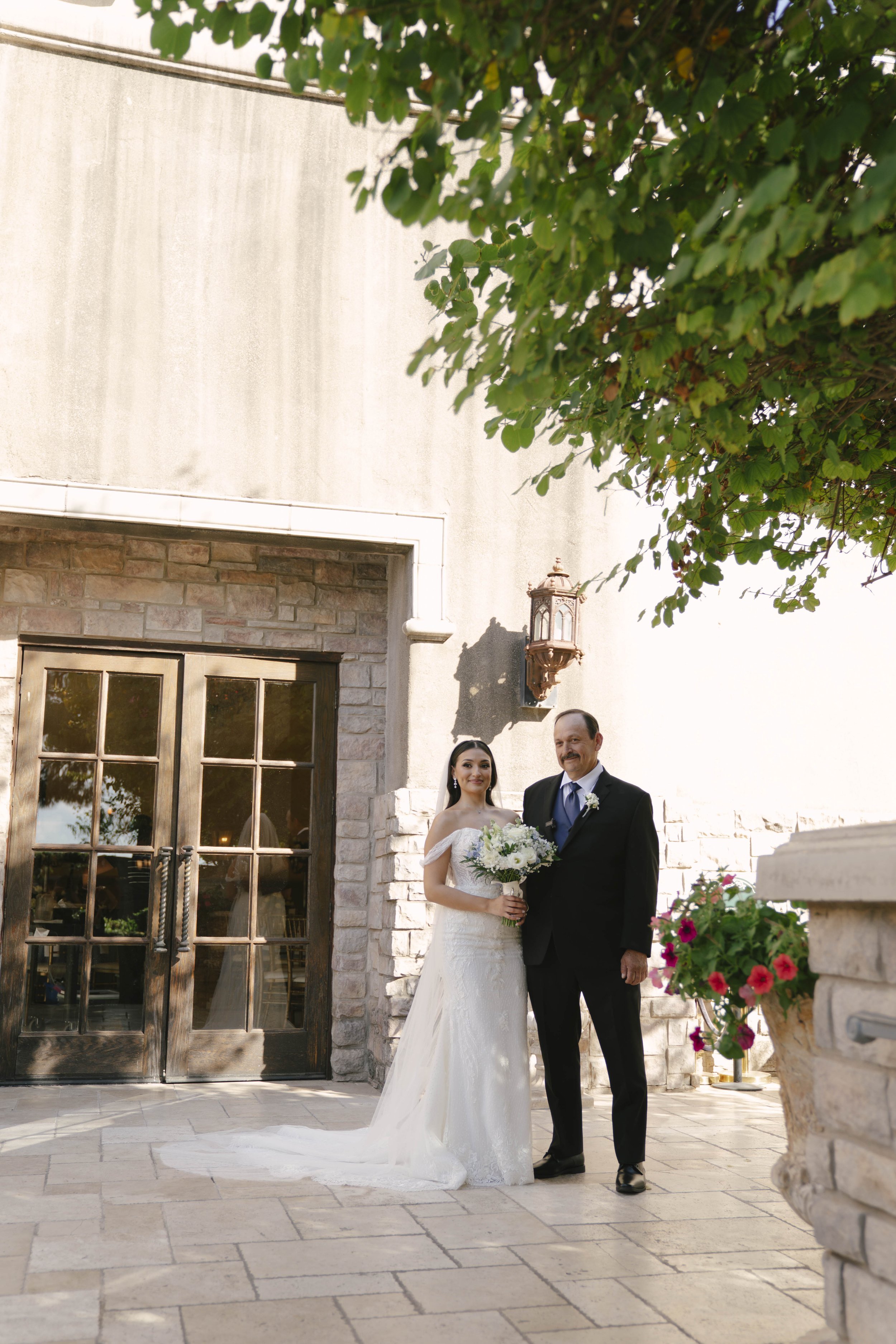 The bride’s first look with her father at Ashley Castle in Chandler, Arizona, was a heartfelt and emotional moment, beautifully documented through hybrid film and digital photography to preserve the joy, love, and anticipation shared before the cerem