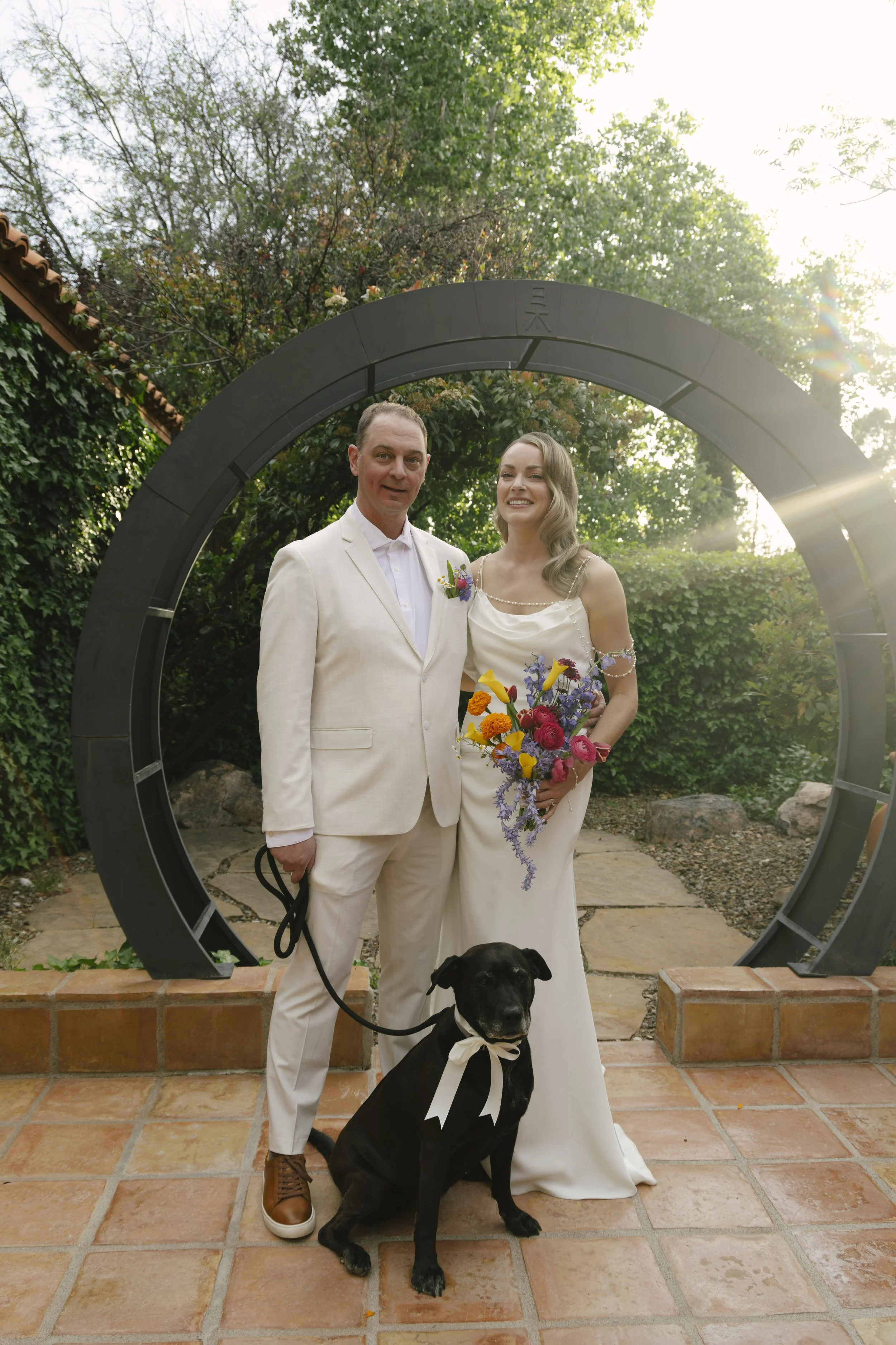 Romantic newlywed portraits from Chelsea and Travis' intimate Sedona, Arizona elopement, featuring elegant courtyard portraits, candid moments with their beloved dog, and timeless wedding photography captured after their private ceremony before golde