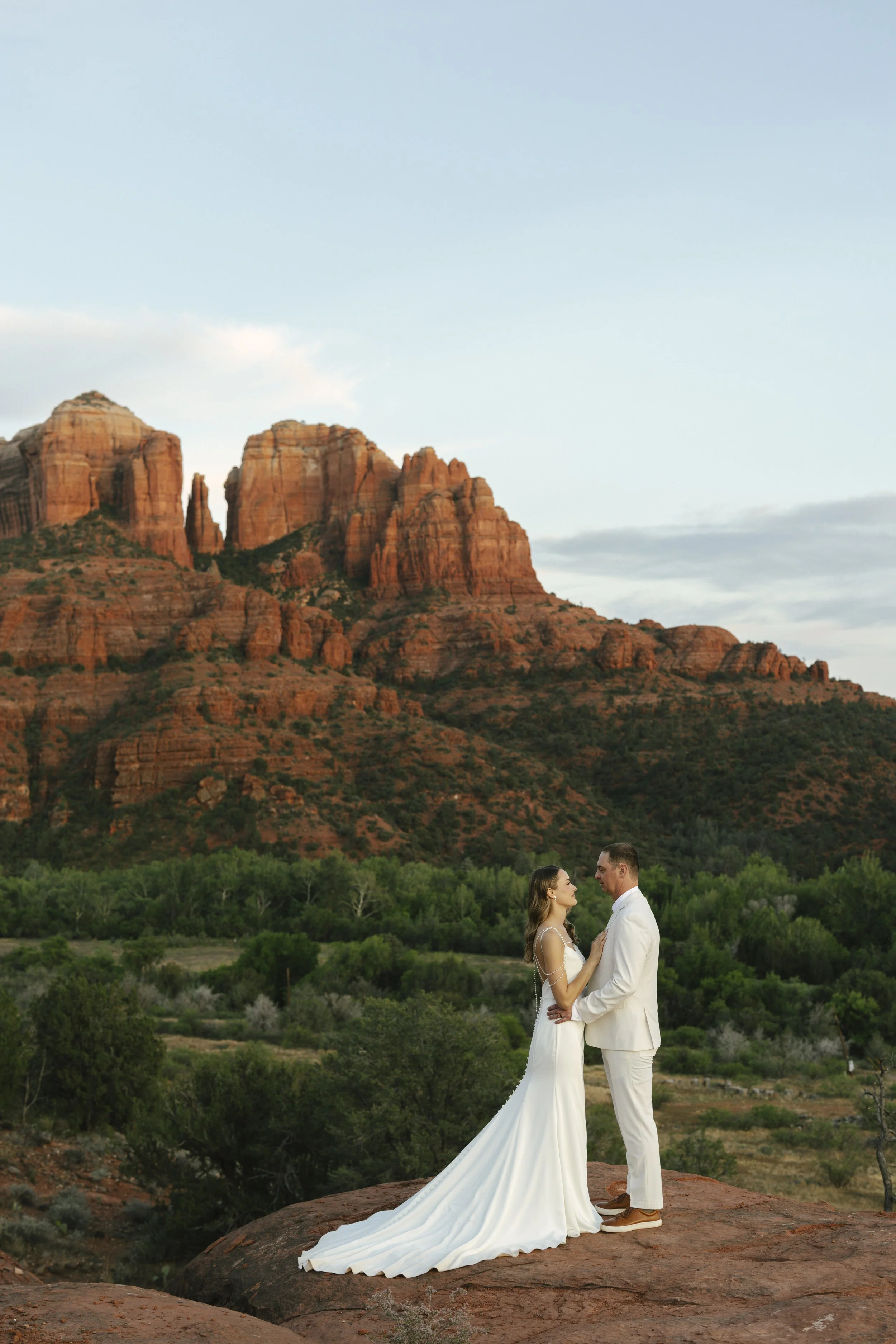 Romantic golden hour portraits at Secret Slick Rock during Chelsea and Travis' intimate Sedona elopement. Featuring Sedona's famous red rock views, stunning Arizona desert landscapes, and timeless wedding photography, these newlywed portraits perfect