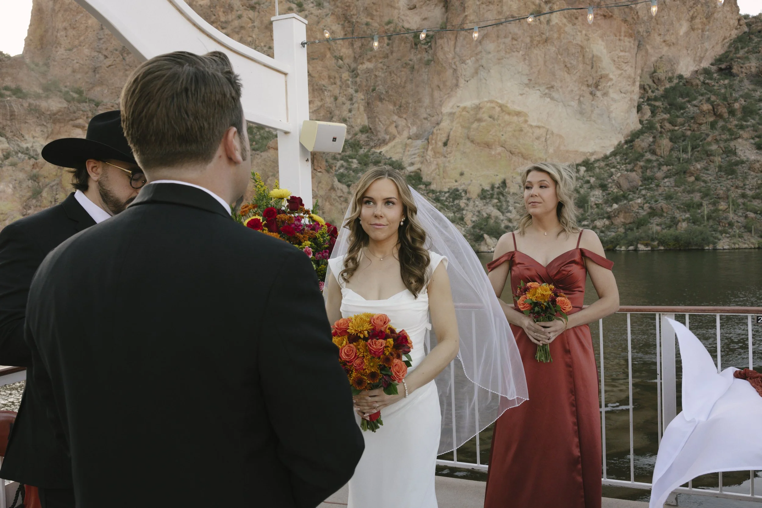 With Canyon Lake’s towering desert cliffs surrounding them, the couple exchanged rings and said “I do” aboard the Dolly Steamboat. Surrounded by about 60 of their closest friends and family, the ceremony took place on the deck with breathtaking Arizo