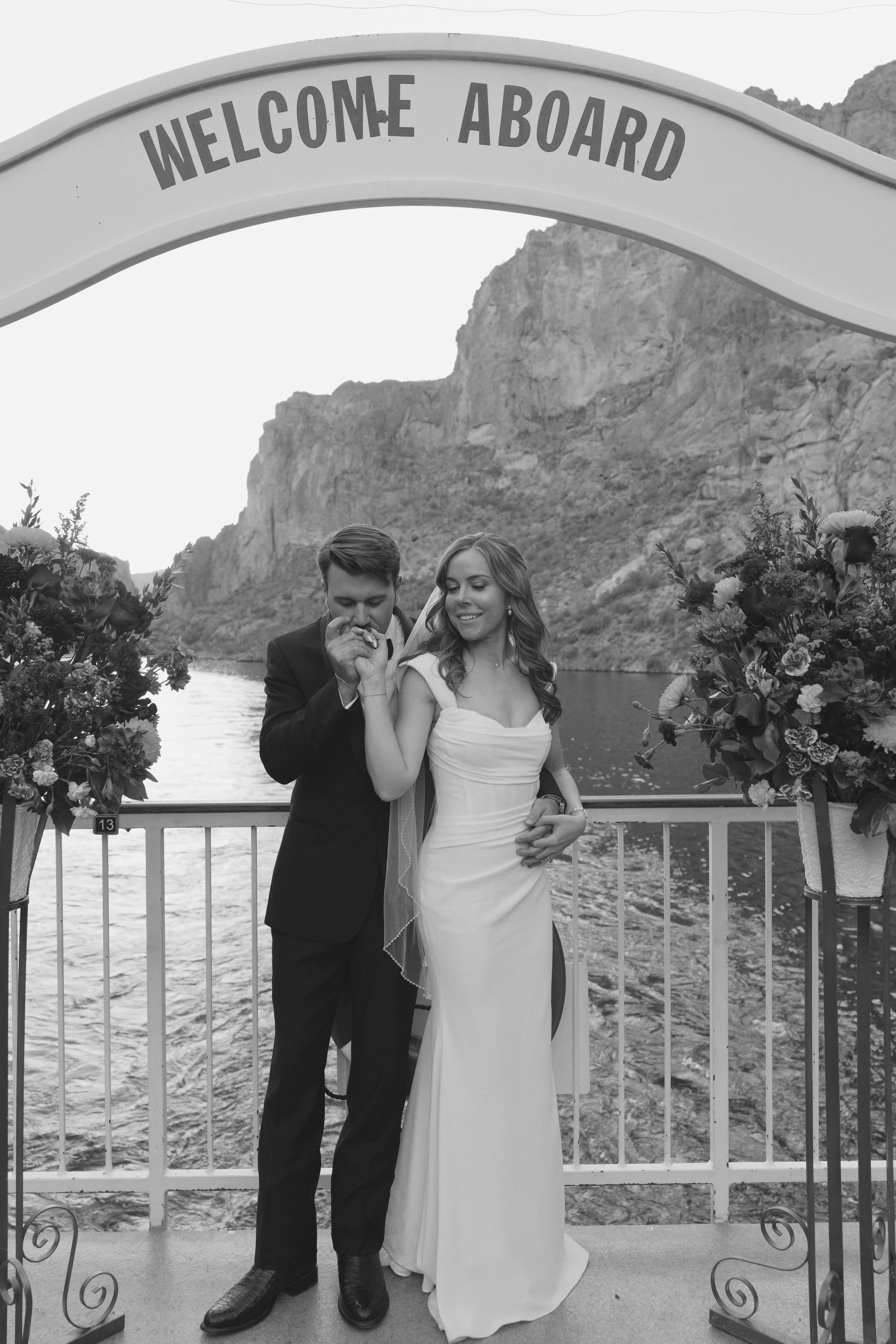 As the sun began to set over Canyon Lake, the couple stepped onto the deck of the Dolly Steamboat for golden hour portraits. With warm Arizona light reflecting off the water and desert mountains surrounding them, these quiet moments captured the beau