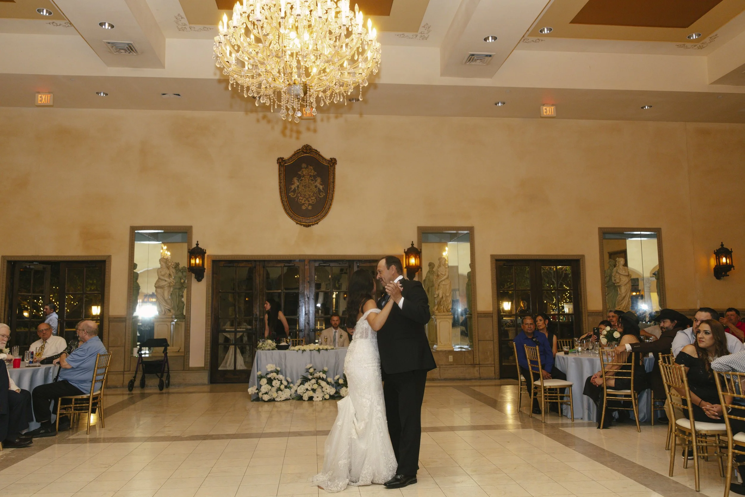 The reception celebration at Ashley Castle in Chandler, Arizona, came to life through hybrid film and digital photography, capturing elegant reception details, joyful bridal party entrances, and lively dance floor moments inside the castle’s grand ba