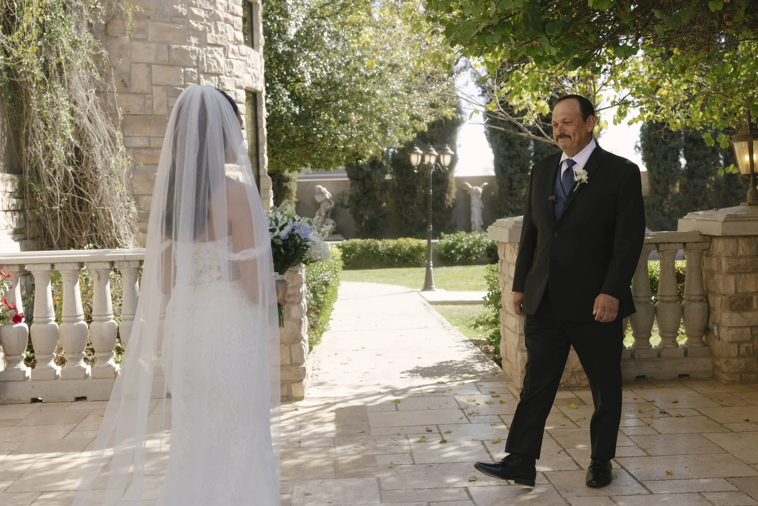 The bride’s first look with her father at Ashley Castle in Chandler, Arizona, was a heartfelt and emotional moment, beautifully documented through hybrid film and digital photography to preserve the joy, love, and anticipation shared before the cerem