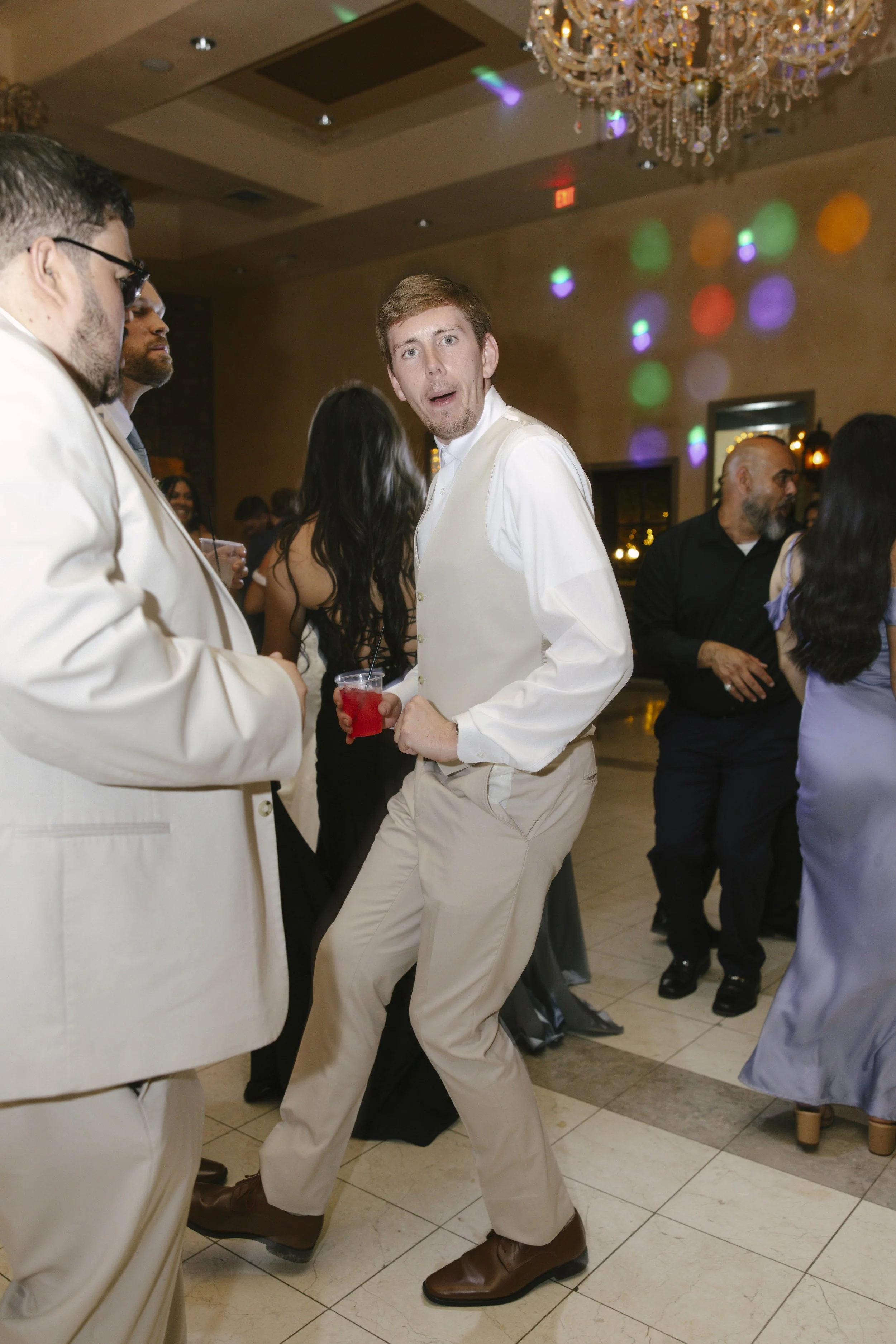 The reception celebration at Ashley Castle in Chandler, Arizona, came to life through hybrid film and digital photography, capturing elegant reception details, joyful bridal party entrances, and lively dance floor moments inside the castle’s grand ba
