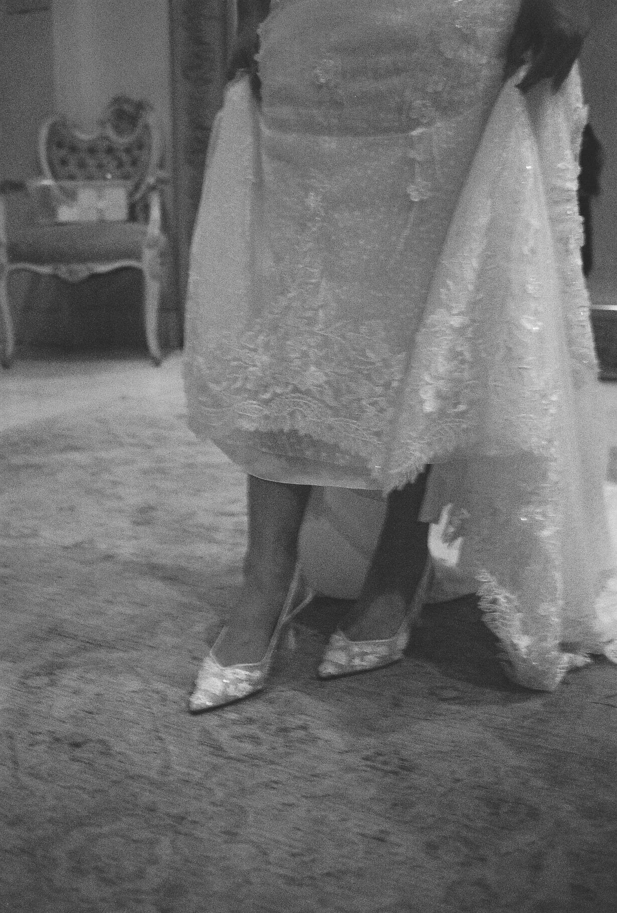 The bride’s final getting-ready moments at Ashley Castle in Chandler, Arizona, were captured through hybrid film and digital photography, preserving the intimate details of dress fastening, veil placement, and bridal finishing touches with timeless e