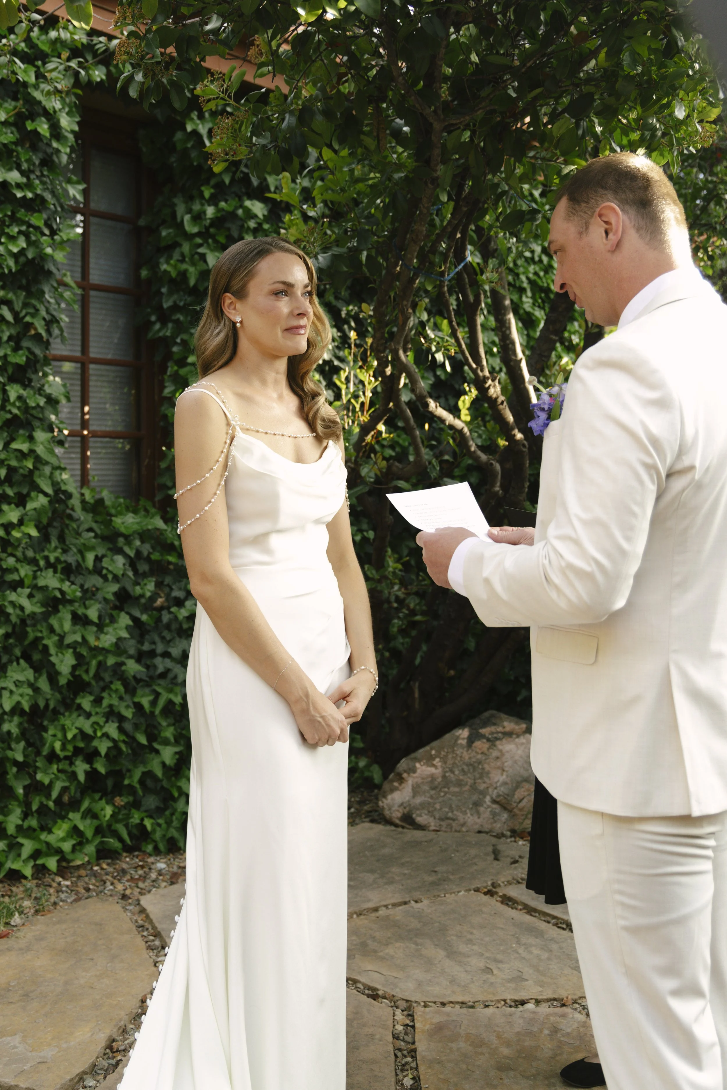 Chelsea and Travis exchanged heartfelt vows during their intimate Sedona elopement at a private Arizona home, surrounded by their closest family, friends, and beloved dog. Their outdoor ceremony was filled with meaningful moments, personal vows, and 