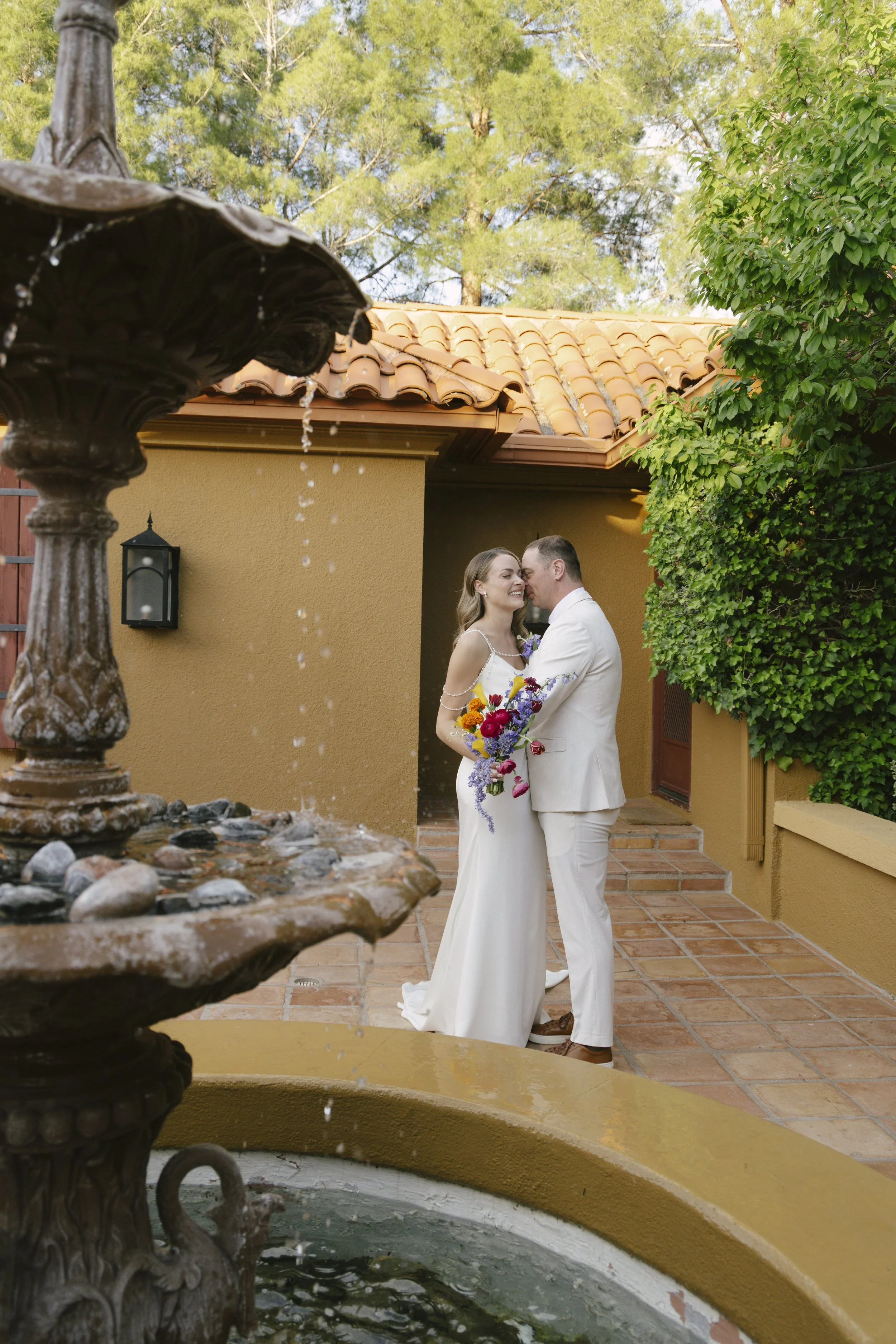 Romantic newlywed portraits from Chelsea and Travis' intimate Sedona, Arizona elopement, featuring elegant courtyard portraits, candid moments with their beloved dog, and timeless wedding photography captured after their private ceremony before golde