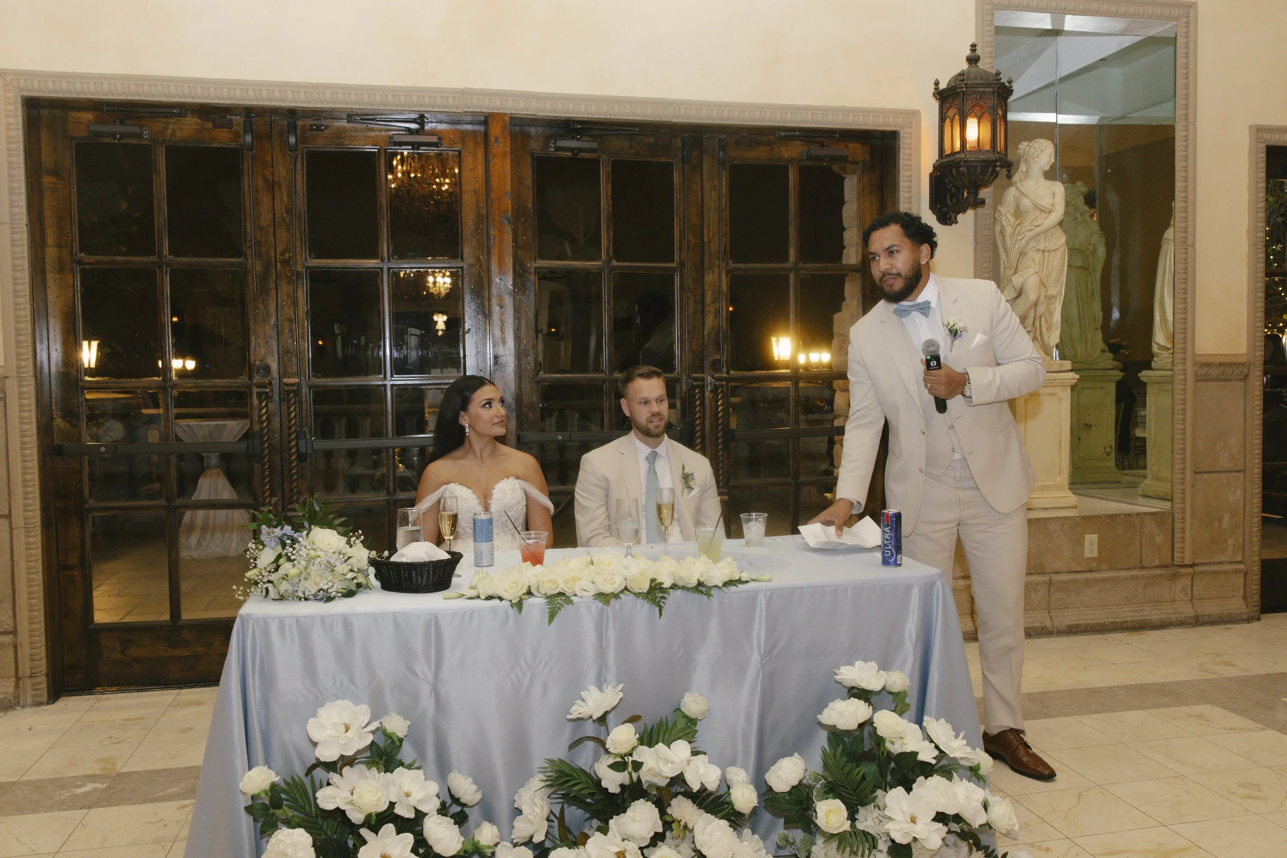 The reception celebration at Ashley Castle in Chandler, Arizona, came to life through hybrid film and digital photography, capturing elegant reception details, joyful bridal party entrances, and lively dance floor moments inside the castle’s grand ba