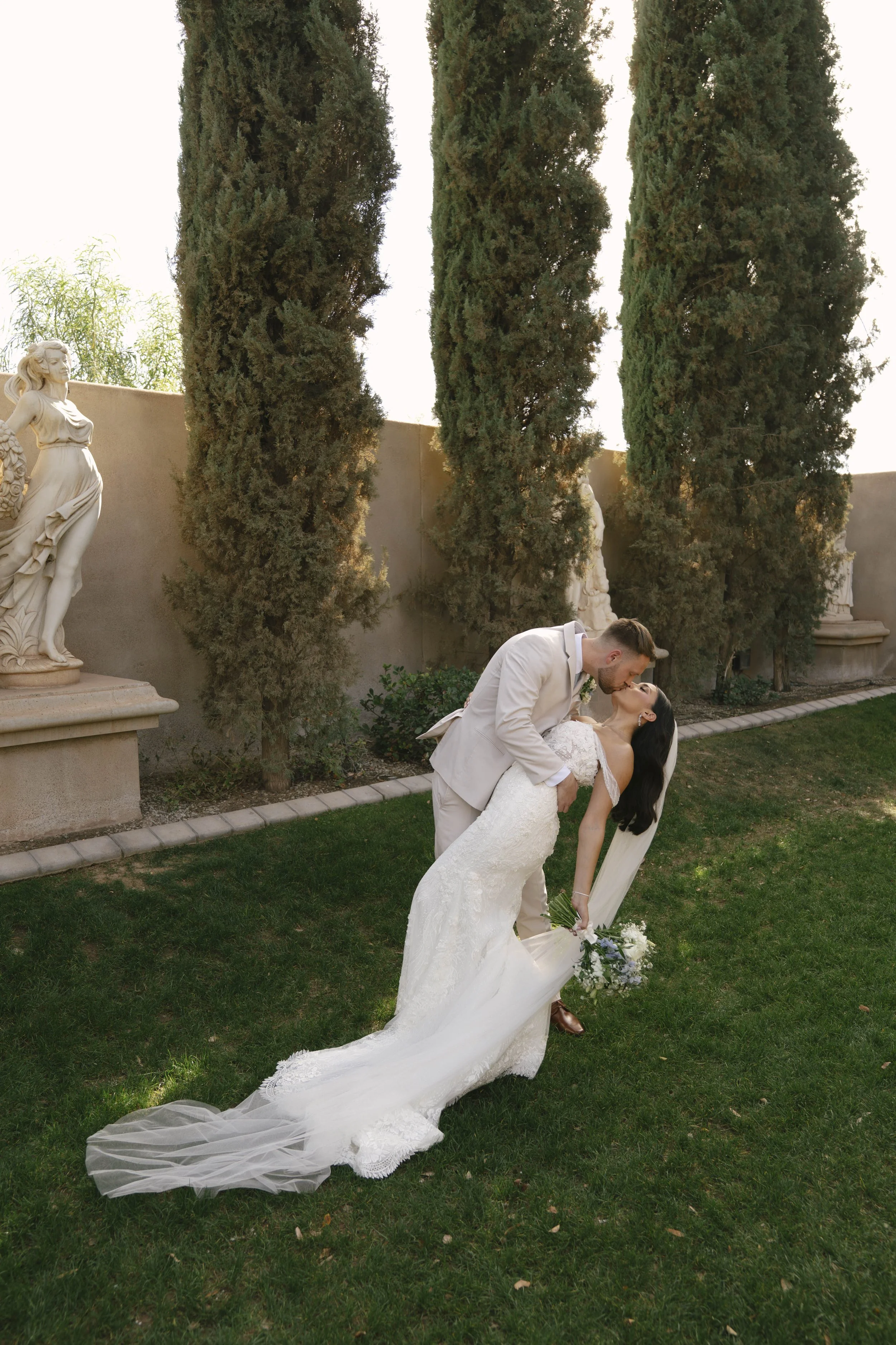 Romantic bride and groom portraits at Ashley Castle in Chandler, Arizona, captured through hybrid film and digital photography, showcase intimate newlywed moments filled with emotion, elegant garden backdrops, and timeless wedding-day connection.