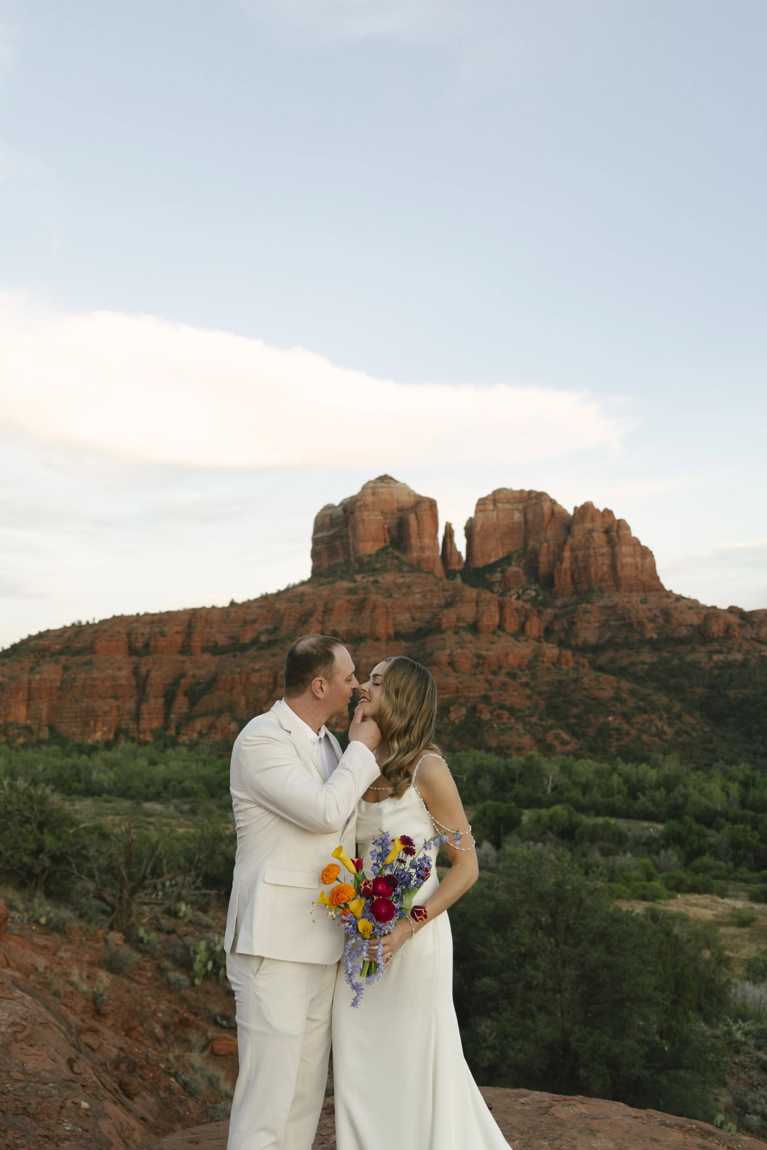 Romantic golden hour portraits at Secret Slick Rock during Chelsea and Travis' intimate Sedona elopement. Featuring Sedona's famous red rock views, stunning Arizona desert landscapes, and timeless wedding photography, these newlywed portraits perfect