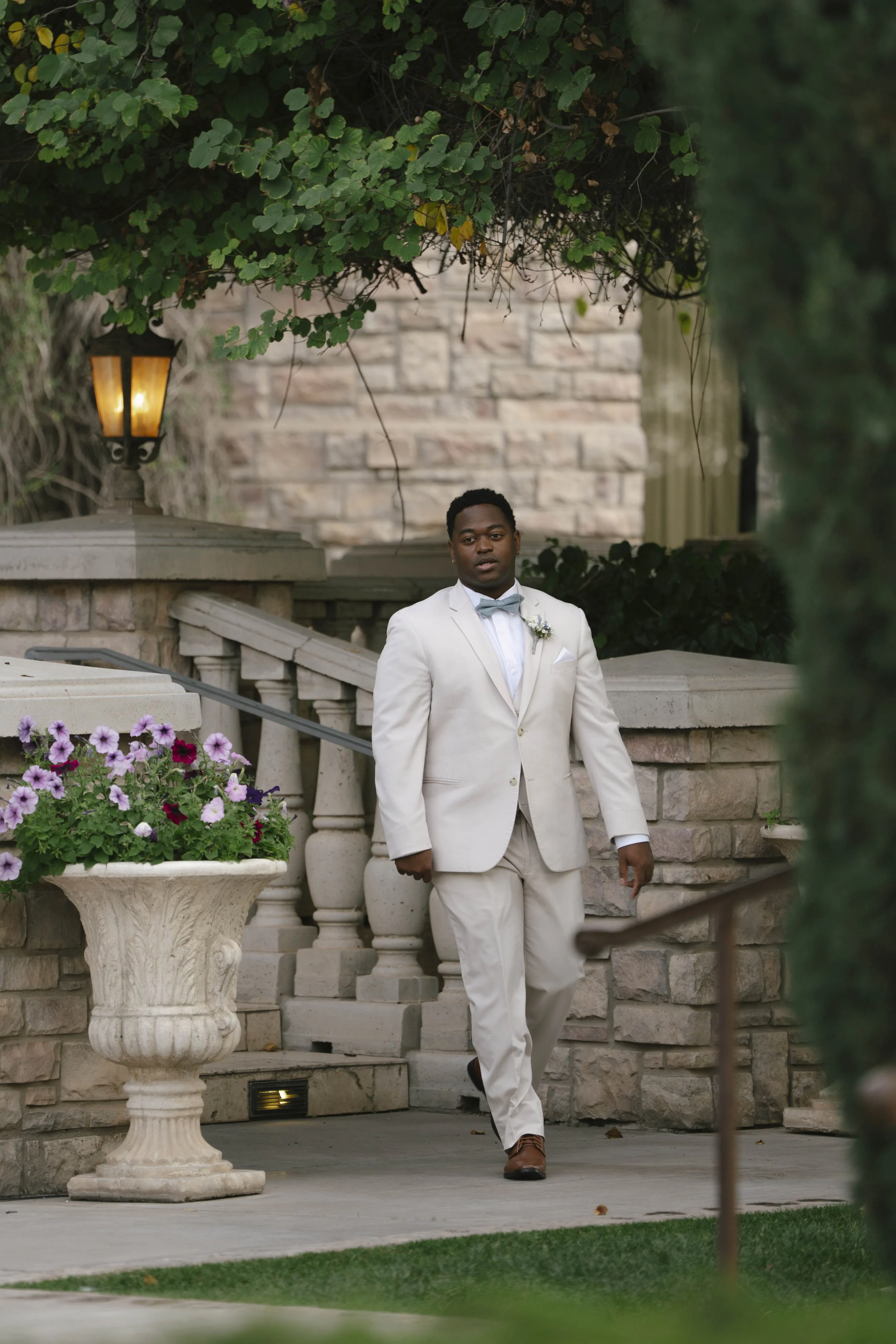 The wedding processional at Ashley Castle in Chandler, Arizona, was captured through hybrid film and digital photography, preserving the graceful entrances of the bridal party as they made their way through the romantic outdoor ceremony space surroun