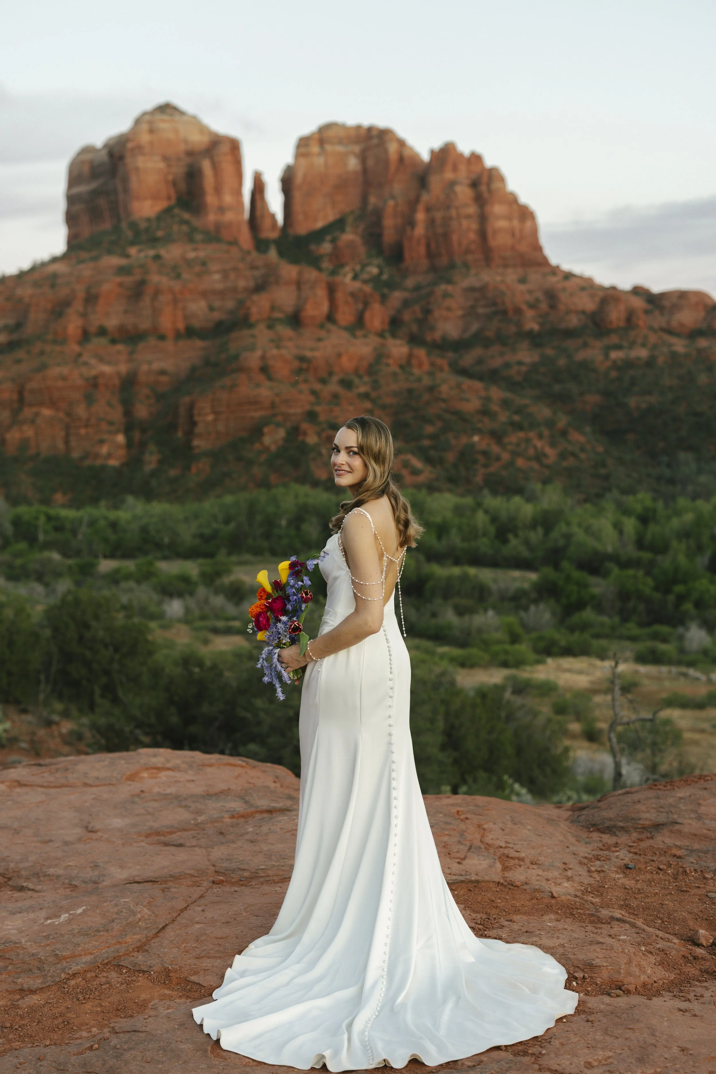 Romantic golden hour portraits at Secret Slick Rock during Chelsea and Travis' intimate Sedona elopement. Featuring Sedona's famous red rock views, stunning Arizona desert landscapes, and timeless wedding photography, these newlywed portraits perfect