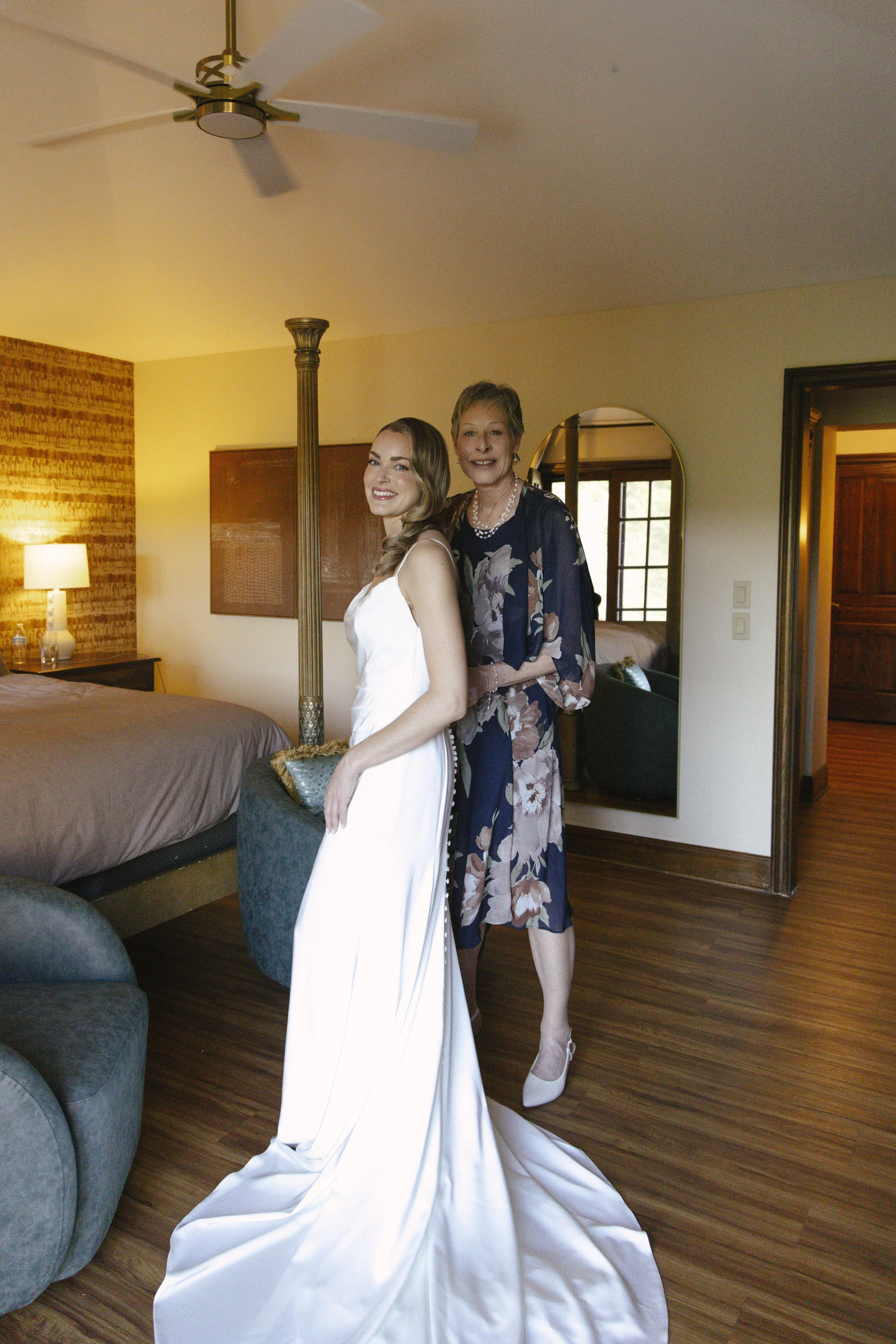 Chelsea and Travis' intimate Sedona elopement continued with heartfelt bridal getting-ready moments as the bride shared meaningful time with her mother and closest loved ones. From fastening her wedding dress and adding the finishing touches to quiet