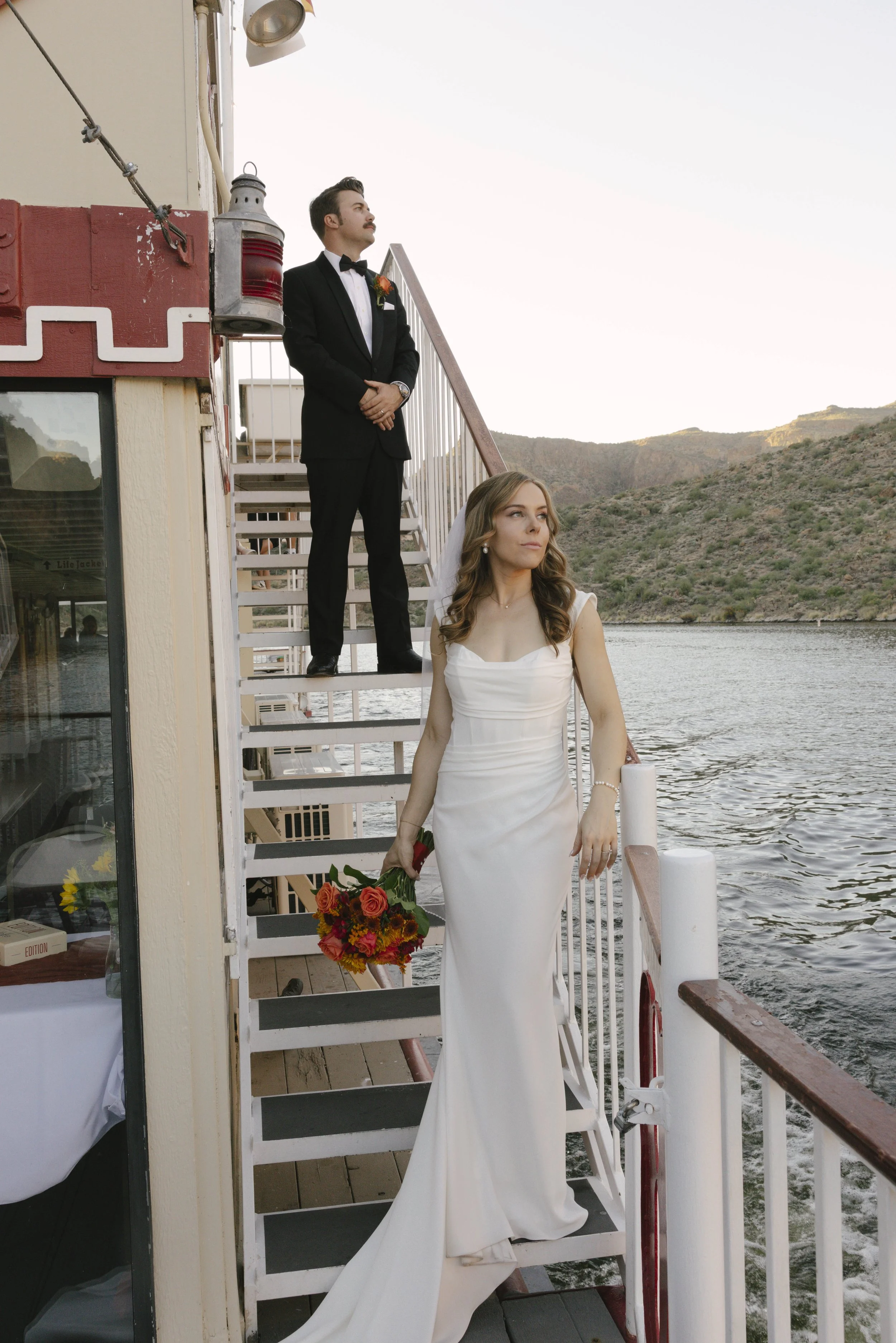 As the sun began to set over Canyon Lake, the couple stepped onto the deck of the Dolly Steamboat for golden hour portraits. With warm Arizona light reflecting off the water and desert mountains surrounding them, these quiet moments captured the beau