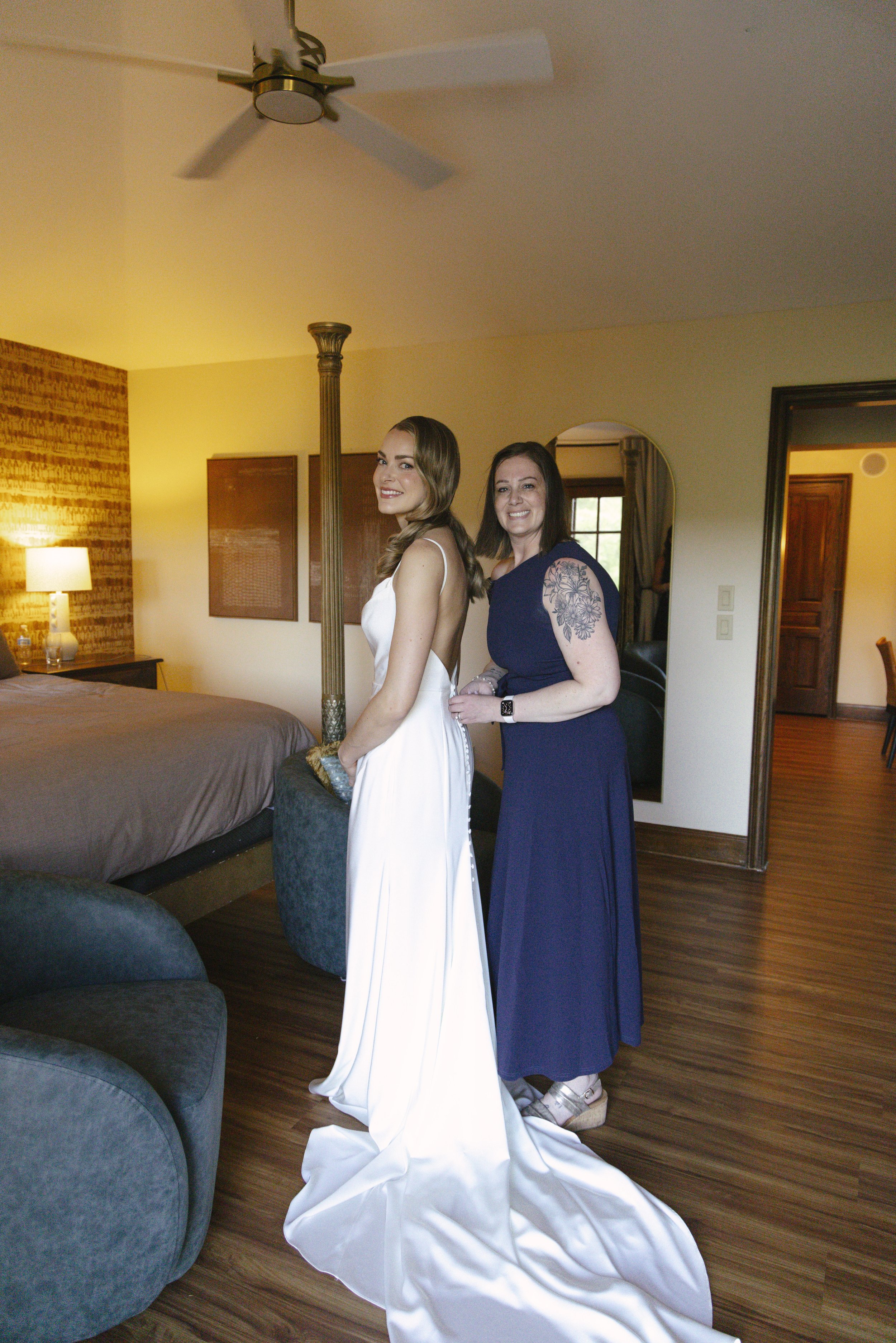 Chelsea and Travis' intimate Sedona elopement continued with heartfelt bridal getting-ready moments as the bride shared meaningful time with her mother and closest loved ones. From fastening her wedding dress and adding the finishing touches to quiet