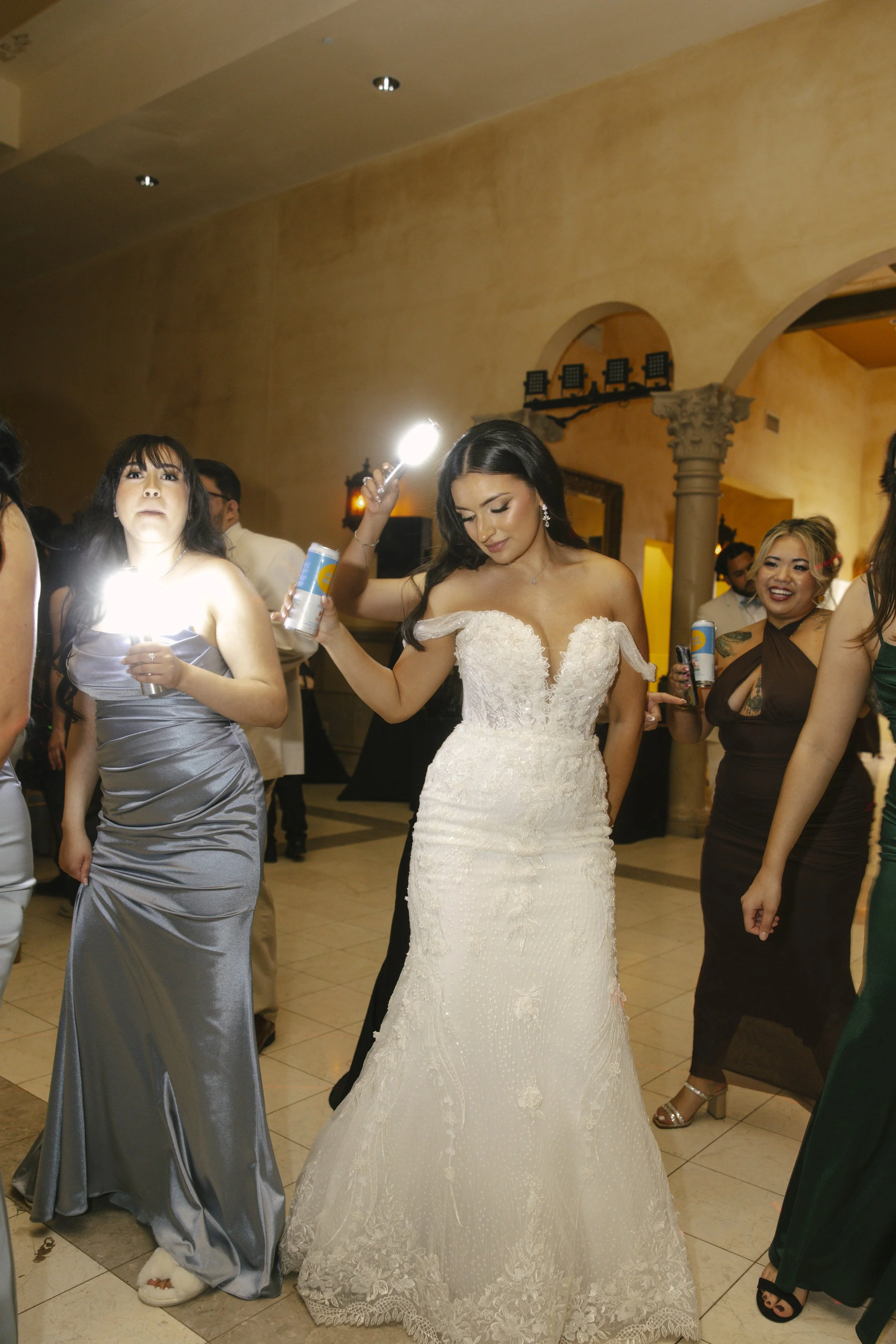 The reception celebration at Ashley Castle in Chandler, Arizona, came to life through hybrid film and digital photography, capturing elegant reception details, joyful bridal party entrances, and lively dance floor moments inside the castle’s grand ba