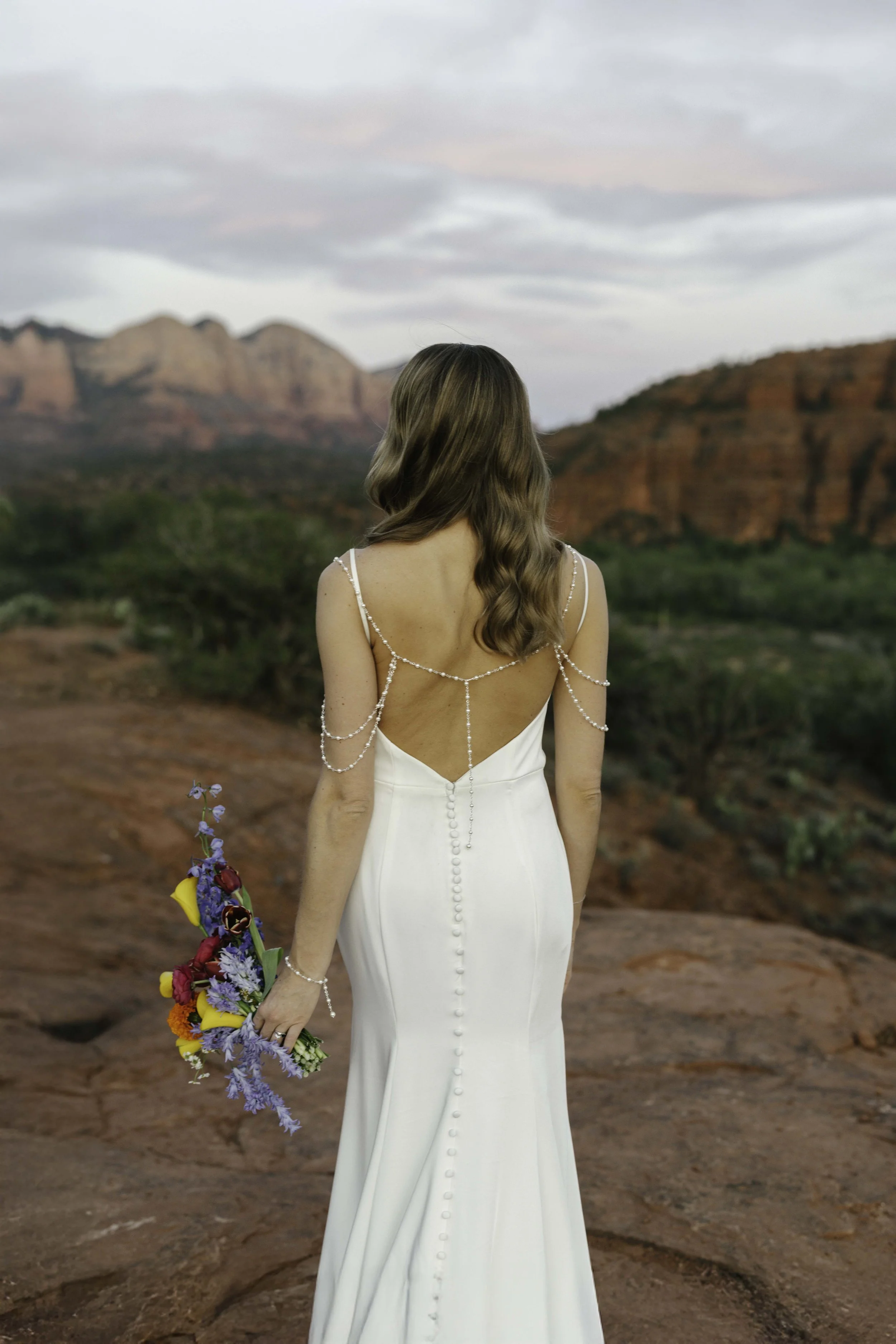 Romantic golden hour portraits at Secret Slick Rock during Chelsea and Travis' intimate Sedona elopement. Featuring Sedona's famous red rock views, stunning Arizona desert landscapes, and timeless wedding photography, these newlywed portraits perfect