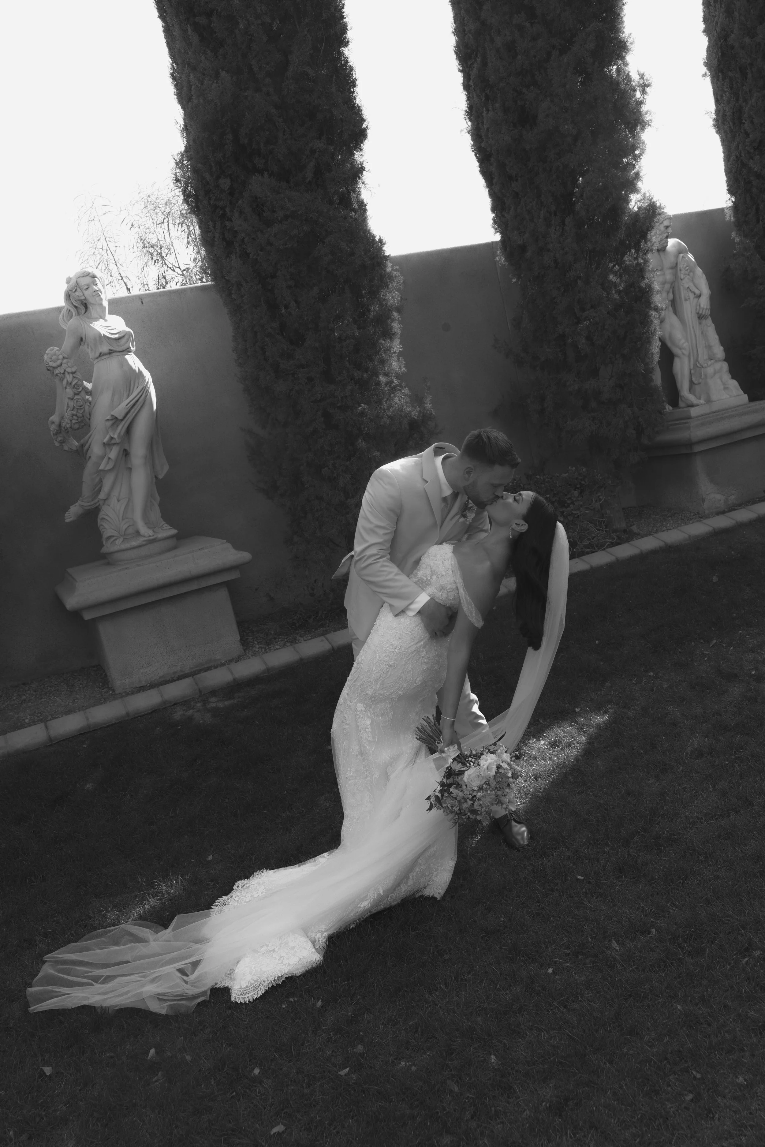 Romantic bride and groom portraits at Ashley Castle in Chandler, Arizona, captured through hybrid film and digital photography, showcase intimate newlywed moments filled with emotion, elegant garden backdrops, and timeless wedding-day connection.