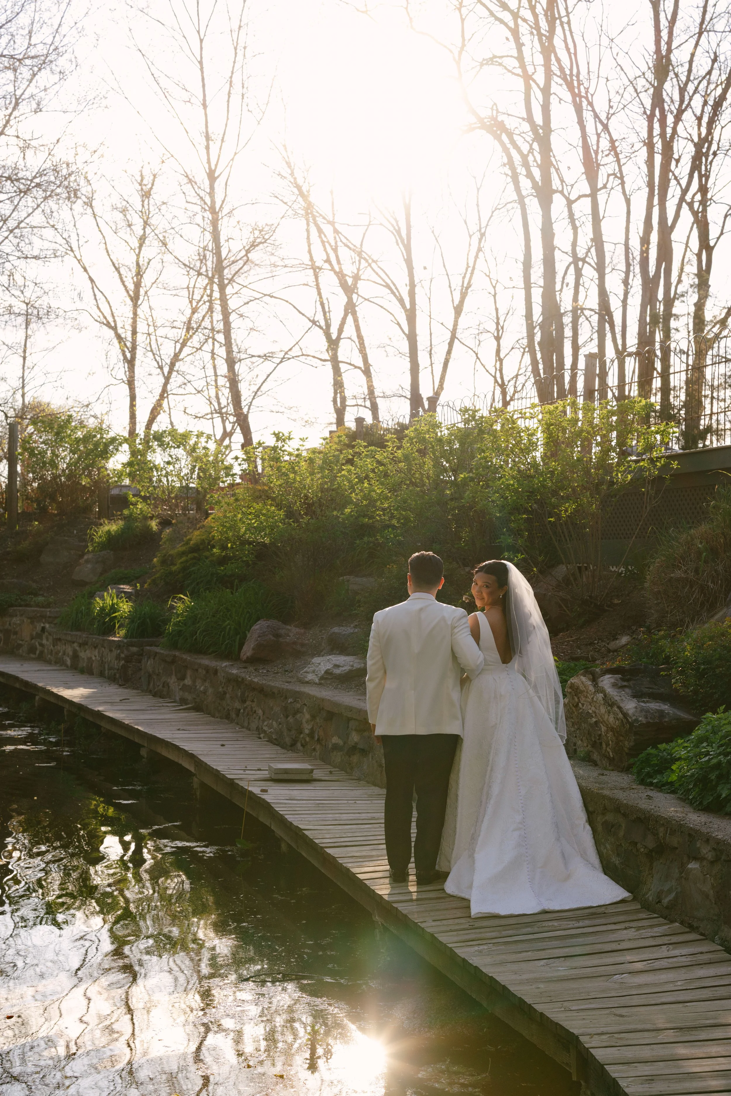 Bride and groom portraits at Hotel DuVillage showcase the venue's picturesque gardens, waterfront views, and timeless charm. Photographed on both digital and 35mm film, these wedding portraits focus on authentic connection, natural movement, and cand