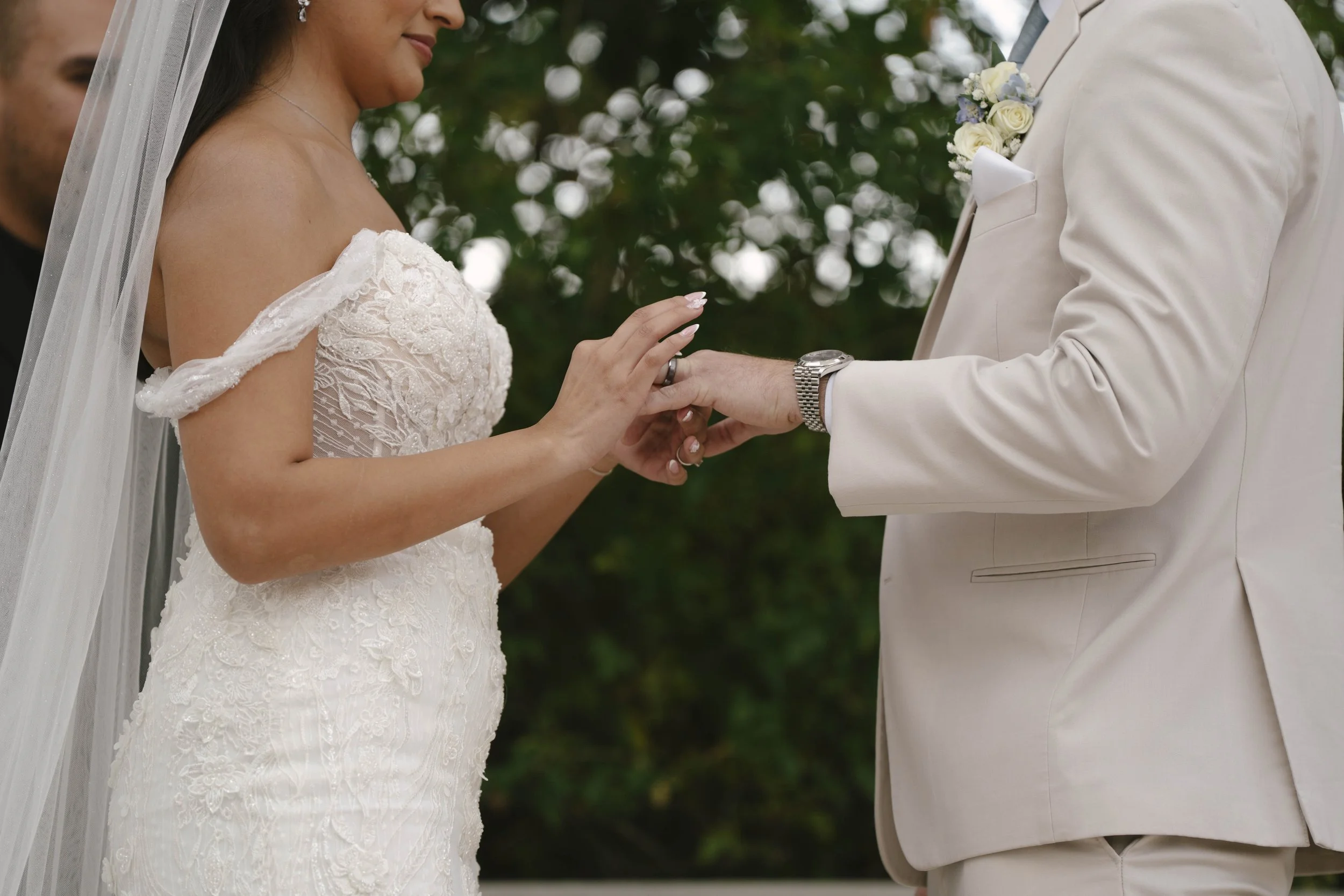 The bride and groom’s ceremony at Ashley Castle in Chandler, Arizona, was beautifully documented through hybrid film and digital photography, capturing their vows, ring exchange, and heartfelt moments beneath a romantic floral altar in the castle’s e