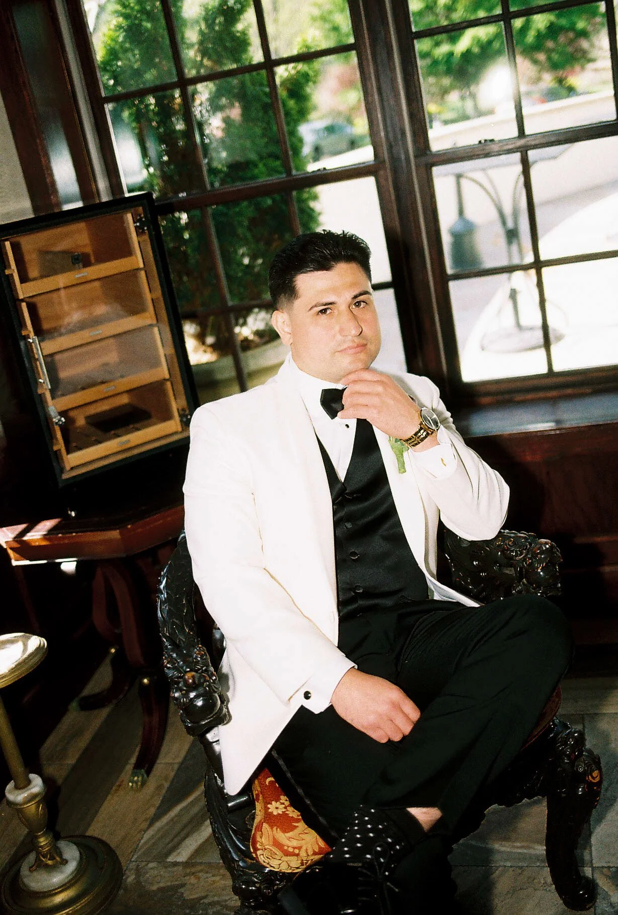 Groom getting ready at Hotel DuVillage before Andy & Elmer's May 2026 wedding. Captured by Raw By Laura using a blend of digital and 35mm film photography, documenting genuine moments with family and friends.