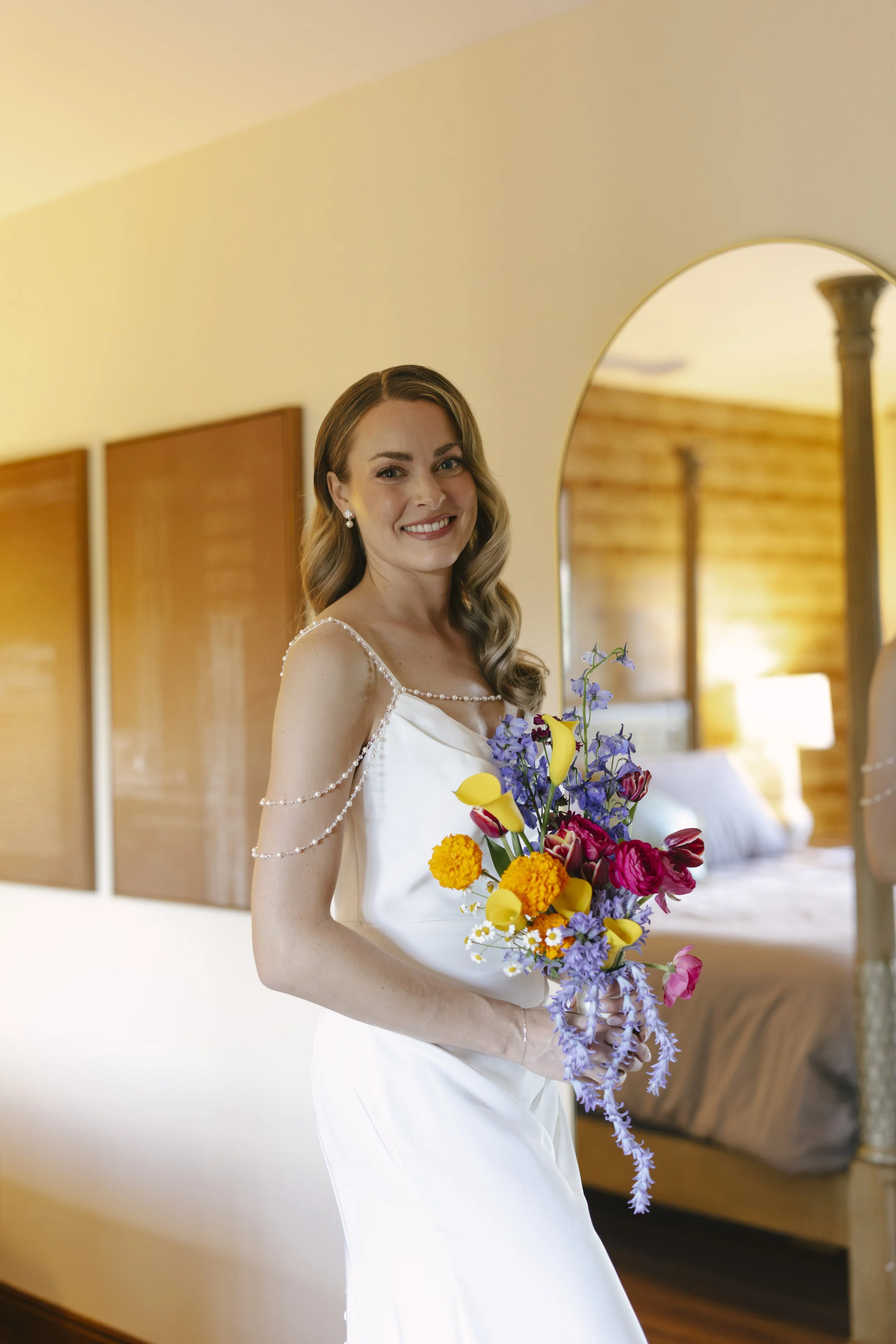 Chelsea and Travis' intimate Sedona elopement continued with heartfelt bridal getting-ready moments as the bride shared meaningful time with her mother and closest loved ones. From fastening her wedding dress and adding the finishing touches to quiet