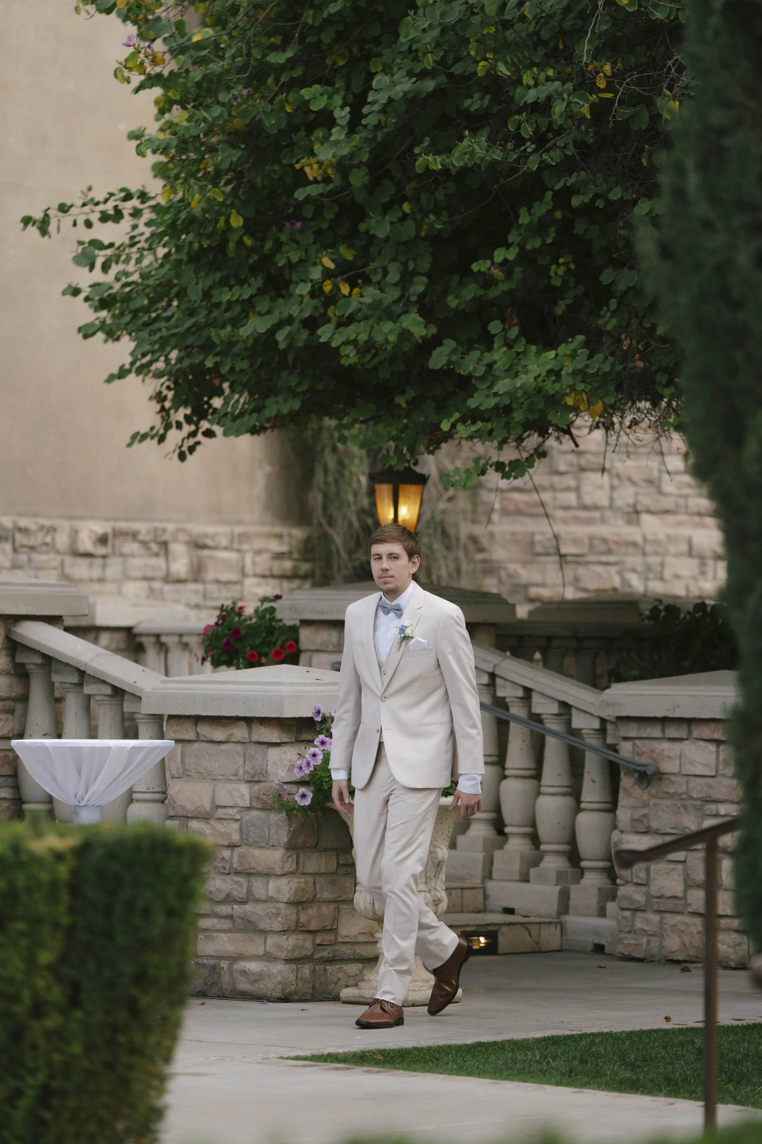 The wedding processional at Ashley Castle in Chandler, Arizona, was captured through hybrid film and digital photography, preserving the graceful entrances of the bridal party as they made their way through the romantic outdoor ceremony space surroun