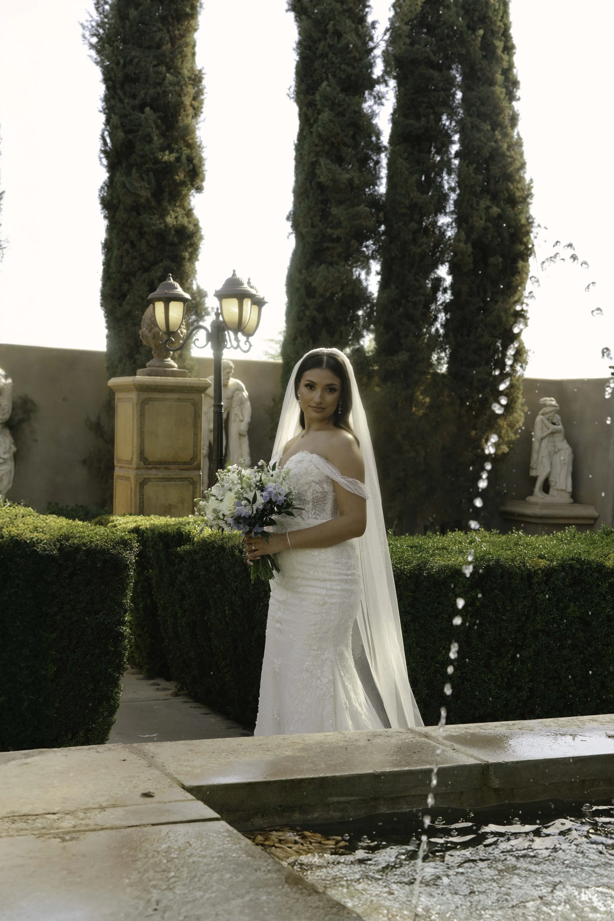 Romantic bride and groom portraits at Ashley Castle in Chandler, Arizona, captured through hybrid film and digital photography, showcase intimate newlywed moments filled with emotion, elegant garden backdrops, and timeless wedding-day connection.